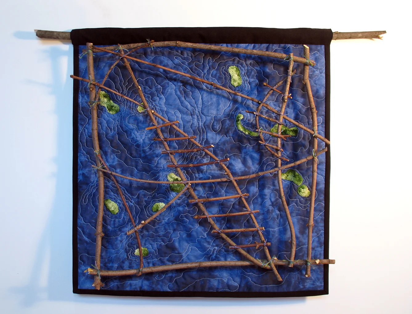 Reading the Waves: Found sticks, embroidery thread. Hand stitched French knots, machine quilted. (22" x 22")
