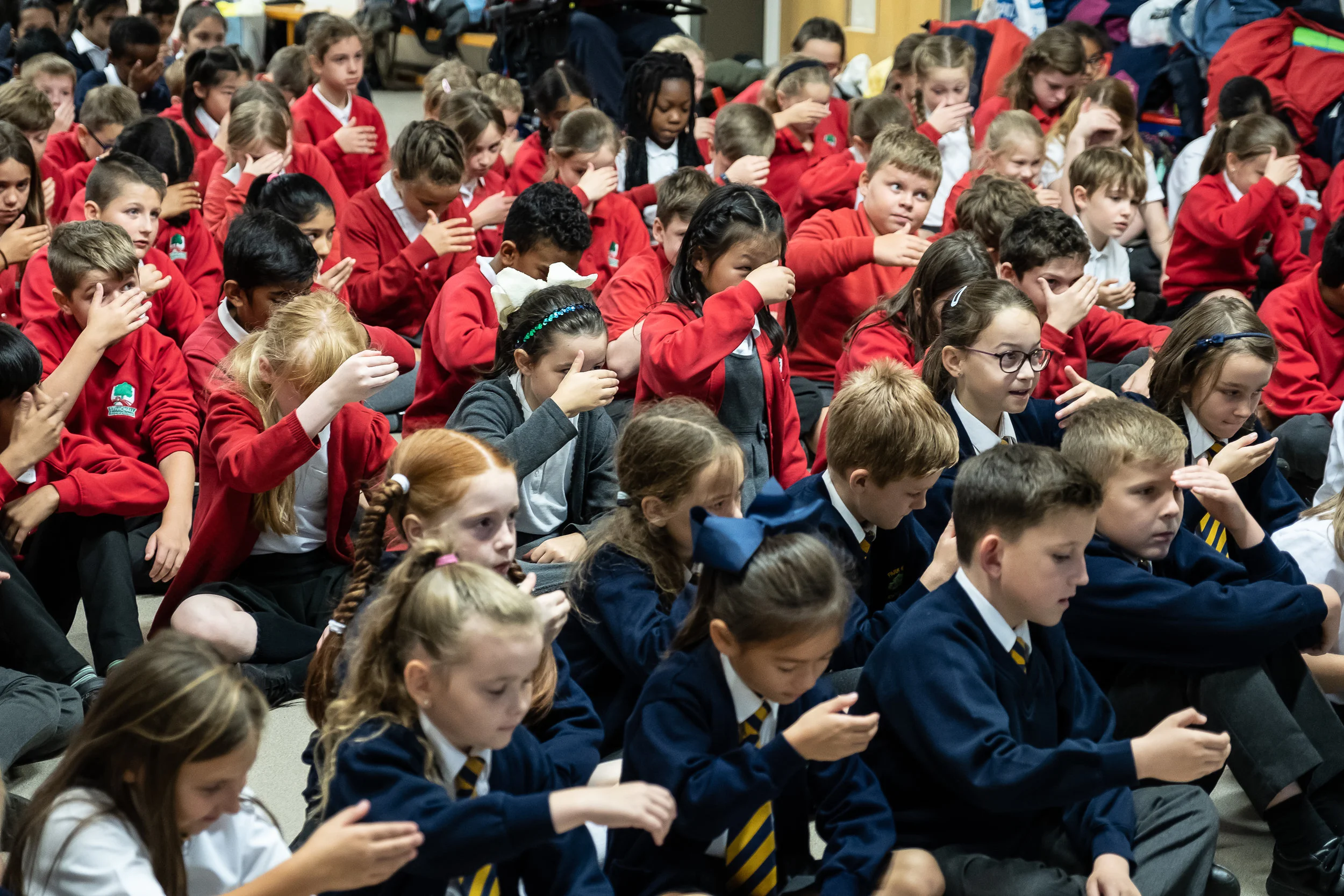 180 Coventry Primary School Children and their teachers attended a ‘Getting to Noh’ workshop organised by the Japan Society and the Between the Stones Project. Here the children are learning about the symbolic hand gesture in noh, called the ‘shiori’ - which demonstrates by ‘scooping up their tears’ signifying sadness.. Photography by Clive Barda