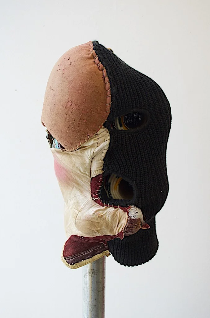Natalie Ball Pussy Hat 2018 balaclava, leather boxing gloves, Hudson's Bay Co. Trade Blanket toilet paper rolls, sinew thread, blush, human hair, abalone shells, galvanized pipe with floor flange. (head) 14'' x 7.5'' x 5.5''; (galv. pipe) 5' x 1.25'' x 1''; (floor flange) 1.25'' courtesy of the artist. 