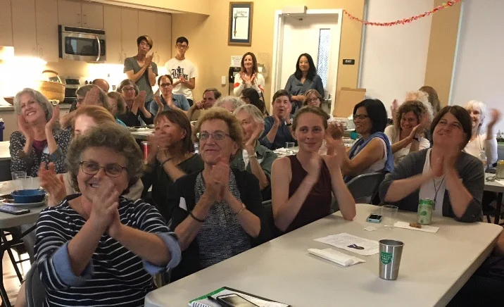 Sister District CA Peninsula members listen to Claudette Williams speaking to us via Skype, during our July meeting.