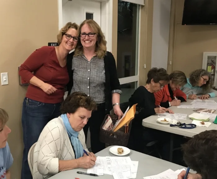 Maureen Murphy and Betsy Adams, District Captain Heads of Postcards, at a postcard writing party in May 2018.
