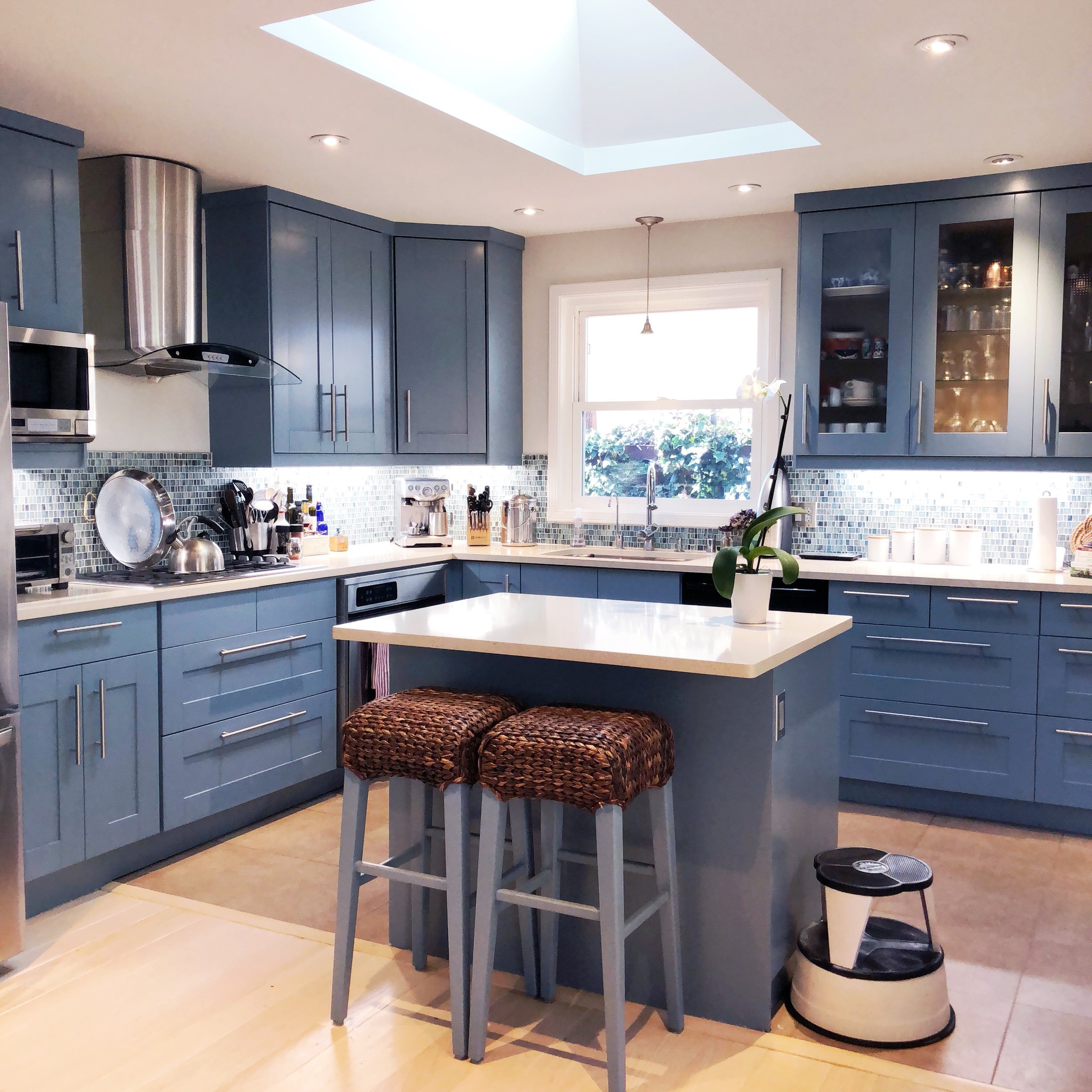 Existing cabinetry spray booth painted, in a new color story to match existing countertops and a new mosaic backsplash.