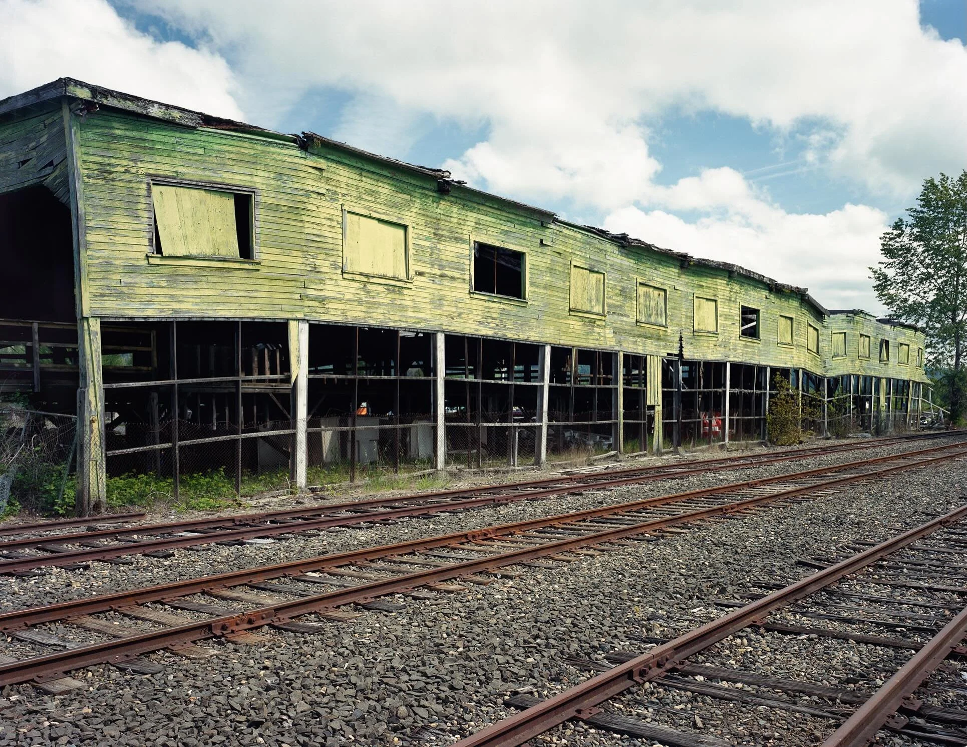 Morning Rhythms, Sweet Home, Oregon

When I first saw this building along the railroad tracks in Sweet Home, Oregon, I was struck with its wavy, oscillating rhythm. As the building contrasted with the rigid perspective of the tracks and soft cloudy s