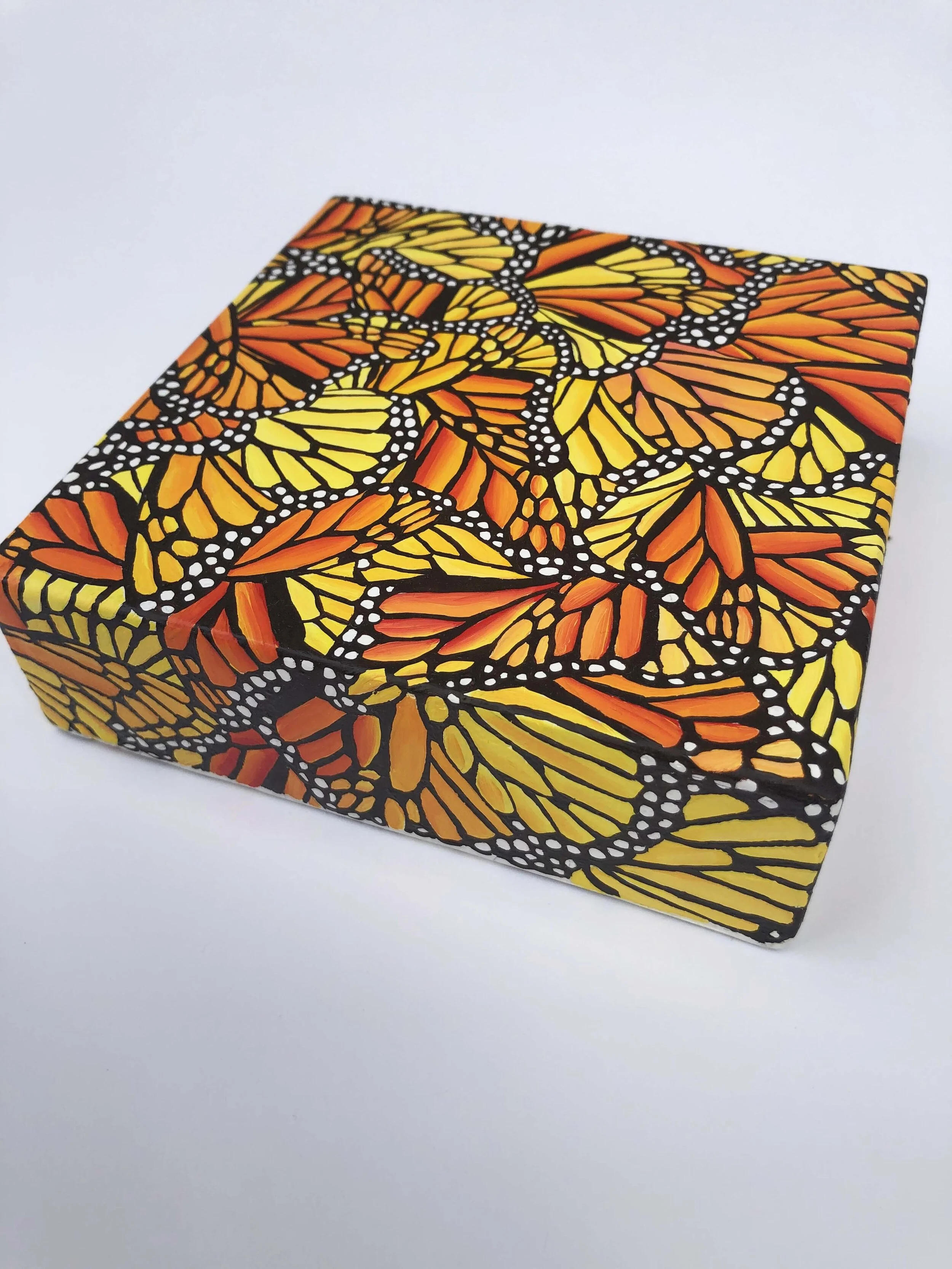 Photo of "Mini Monarch Migration No.1." This is an oil painting by Kristin Frank. It features monarch butterflies clustered together for the winter.