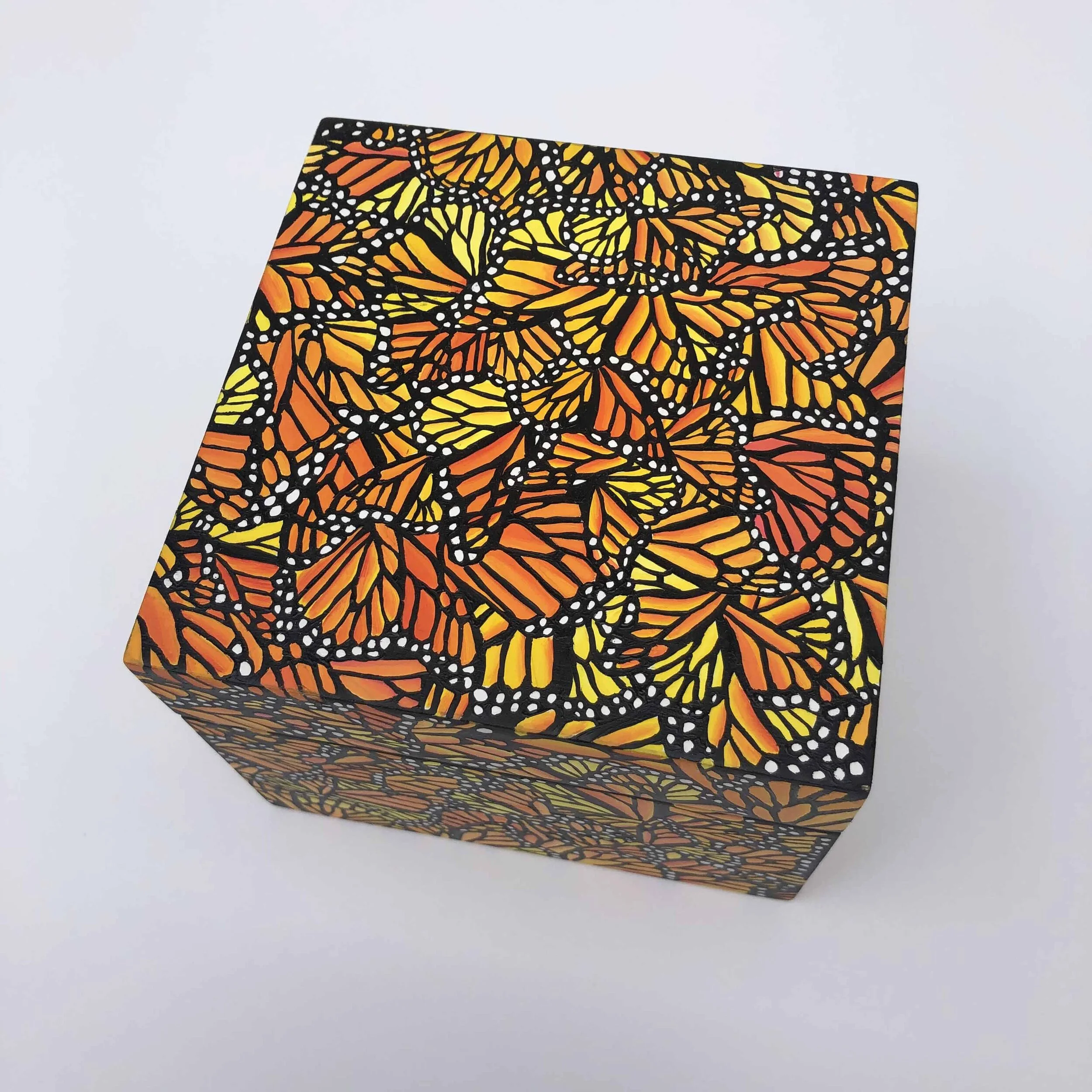 Photo of "Monarch Migration Treasure Box" by artist Kristin Frank. The wooden box features her signature monarch butterfly wing print. She used a wooden Shinola watch box to make this piece.