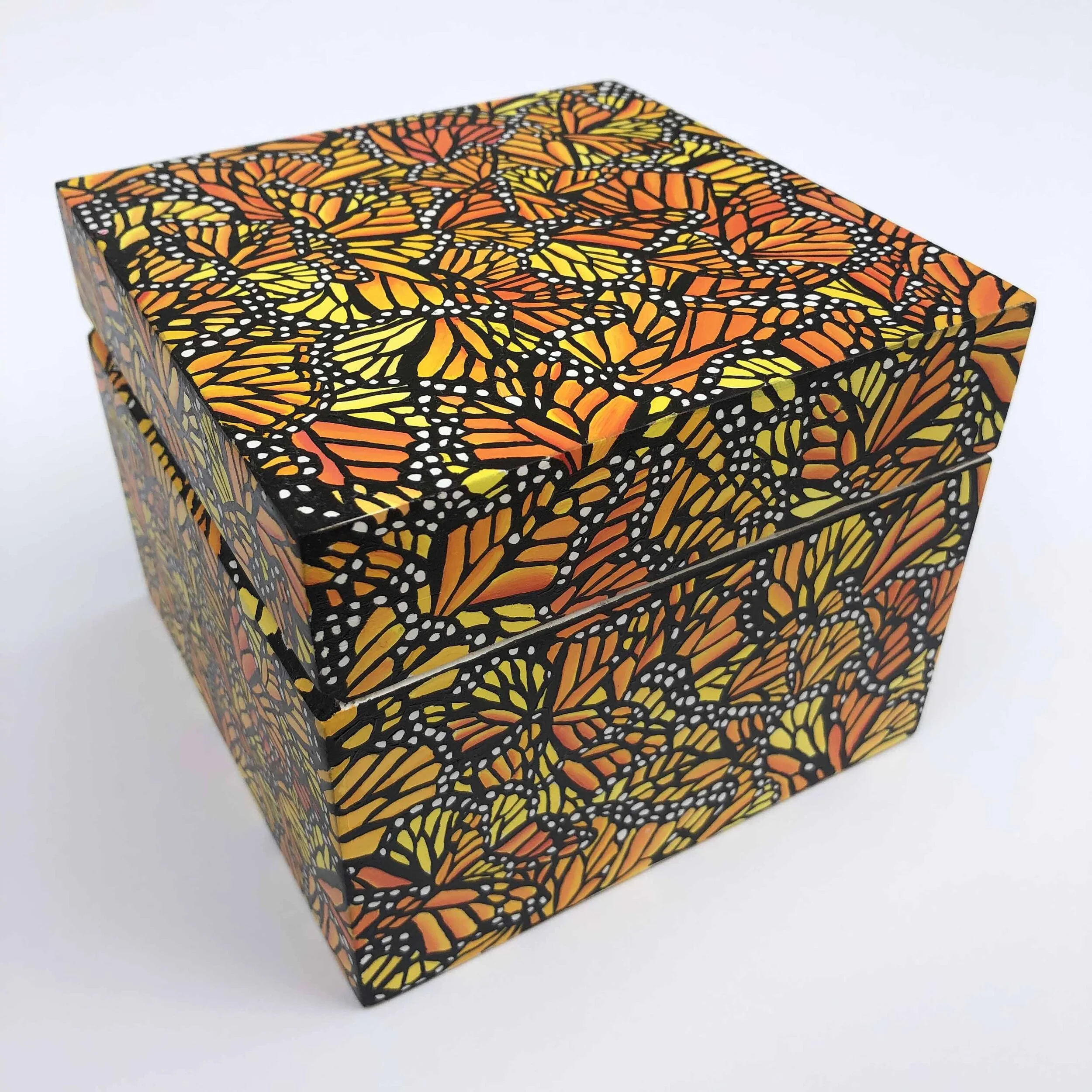 Photo of "Monarch Migration Treasure Box" by artist Kristin Frank. The wooden box features her signature monarch butterfly wing print. She used a wooden Shinola watch box to make this piece.