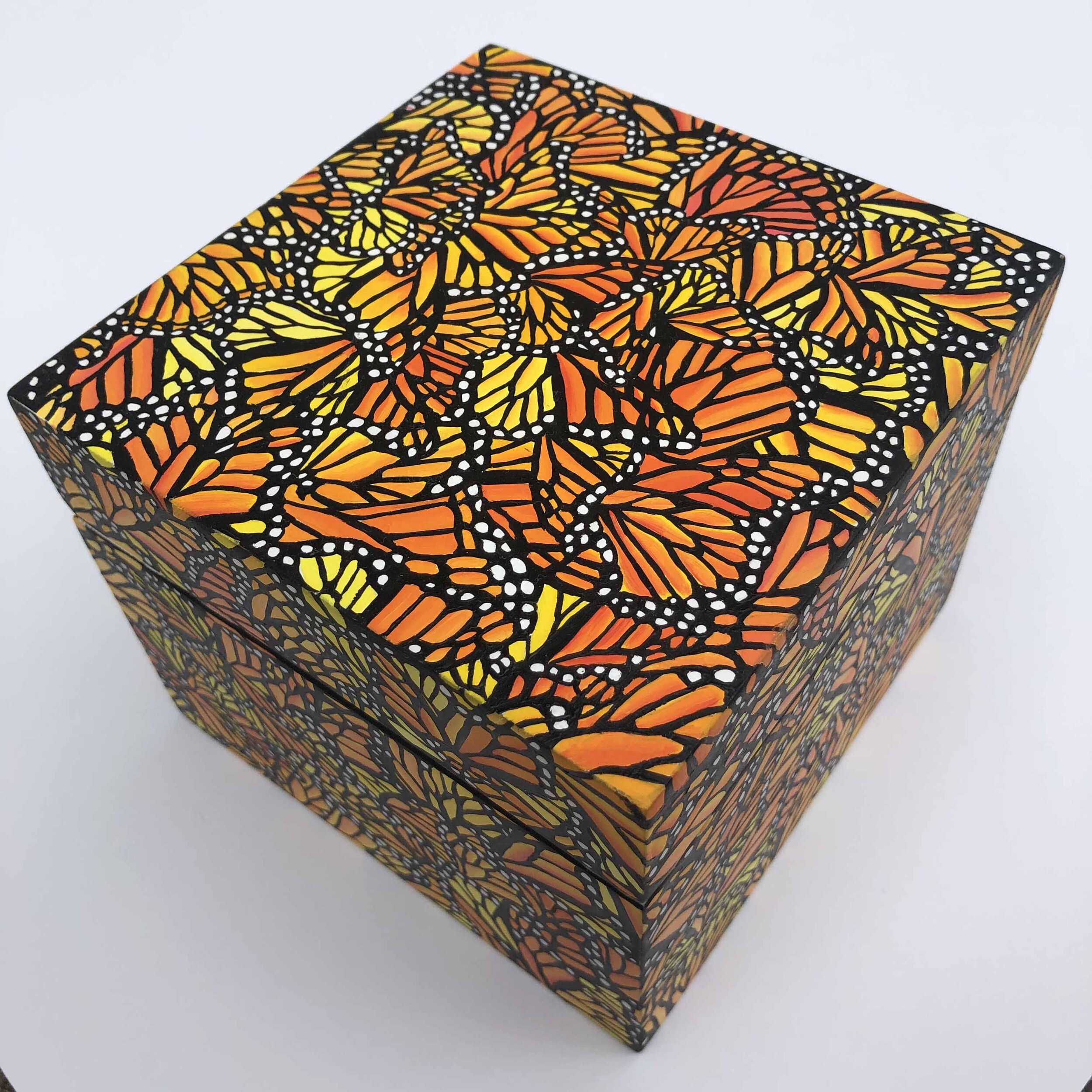 Photo of "Monarch Migration Treasure Box" by artist Kristin Frank. The wooden box features her signature monarch butterfly wing print. She used a wooden Shinola watch box to make this piece.