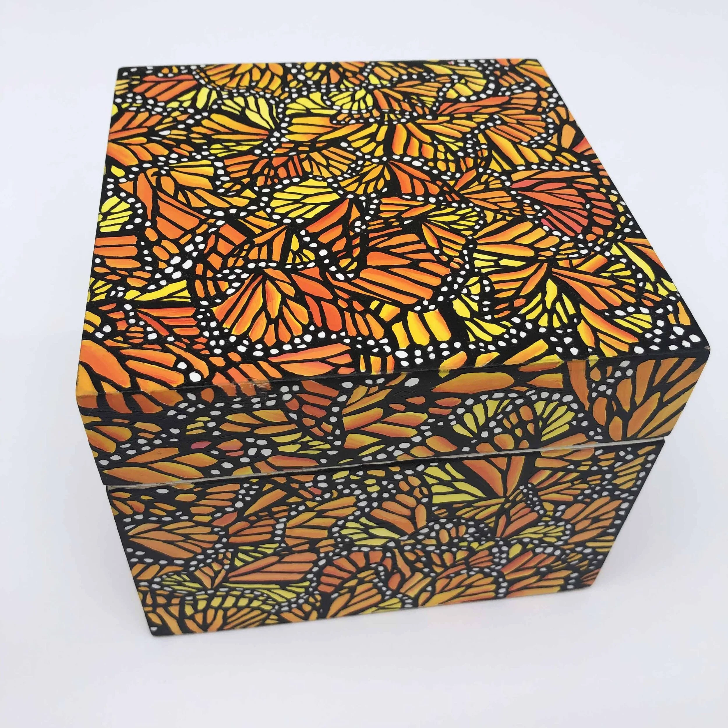 Photo of "Monarch Migration Treasure Box" by artist Kristin Frank. The wooden box features her signature monarch butterfly wing print. She used a wooden Shinola watch box to make this piece.