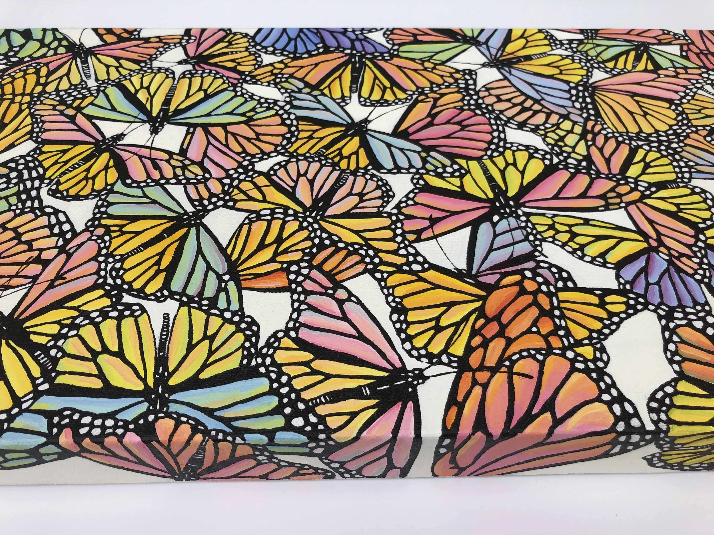 Photo of the oil painting titled "Pastel Monarch Scatter," by Kristin Frank. It features pastel colored monarch butterflies in flight during their migration.