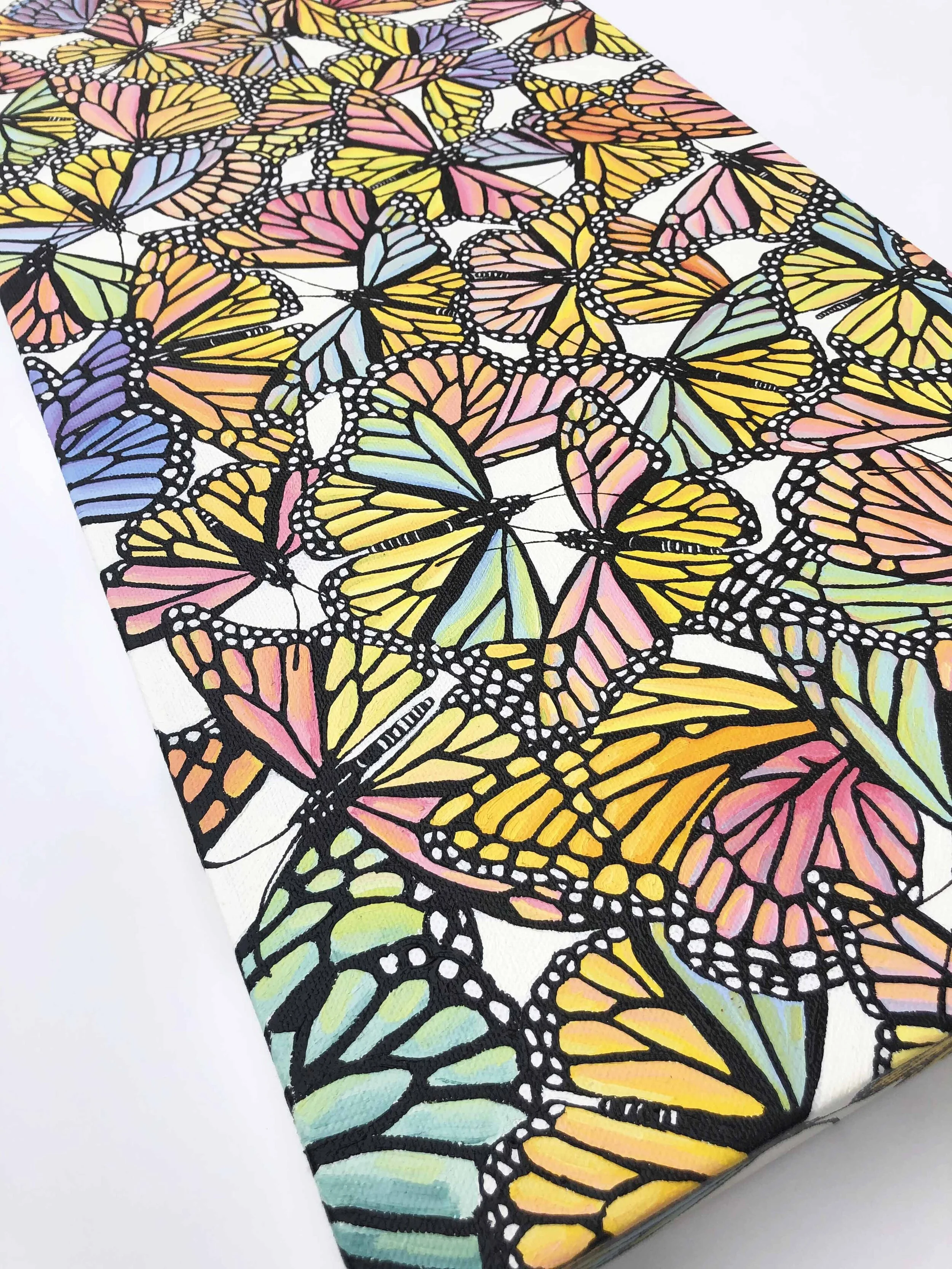 Photo of the oil painting titled "Pastel Monarch Scatter," by Kristin Frank. It features pastel colored monarch butterflies in flight during their migration.