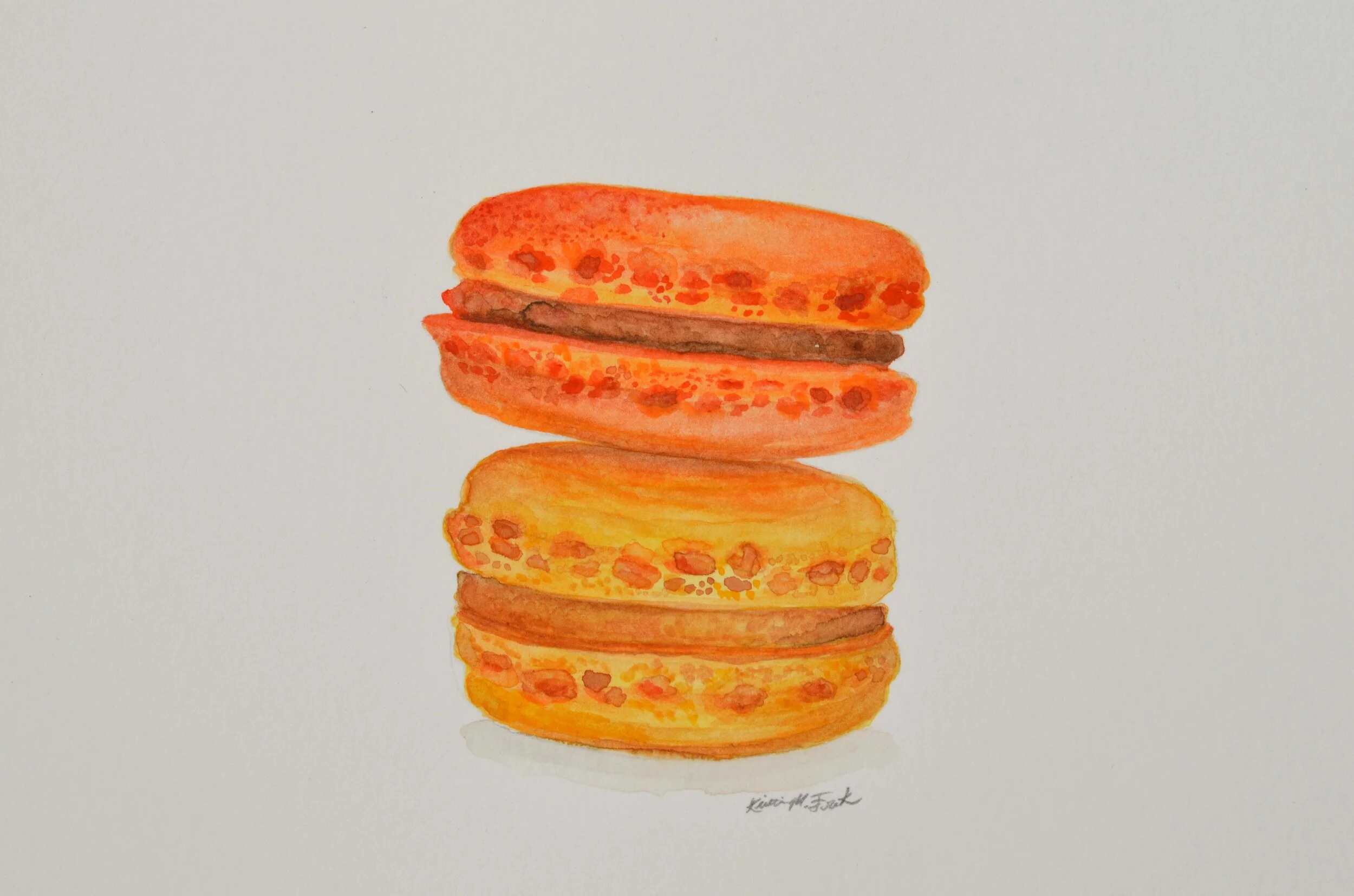 Photo of the watercolor titled "Macaron Monday No.1" by Kristin Frank. The painting features a detailed rendering of two macarons stacked on top of each other. One is orange and one is yellow.