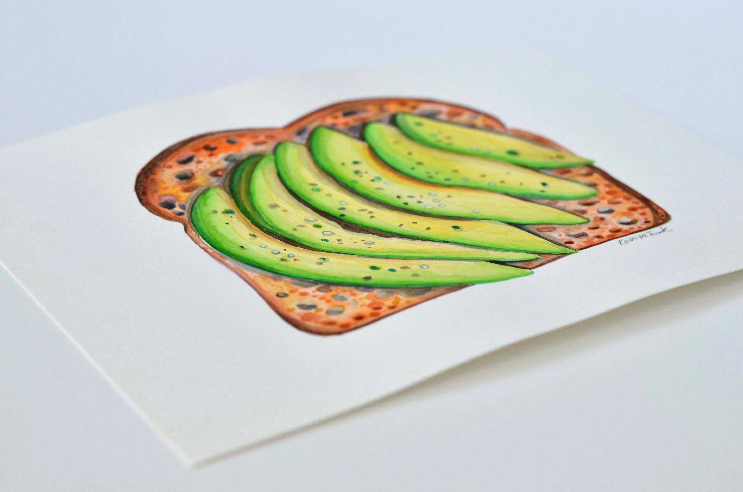 Watercolor of sliced avocado on toast. This painting is titled "Avocado Toast No.1" and it is by Kristin Frank.