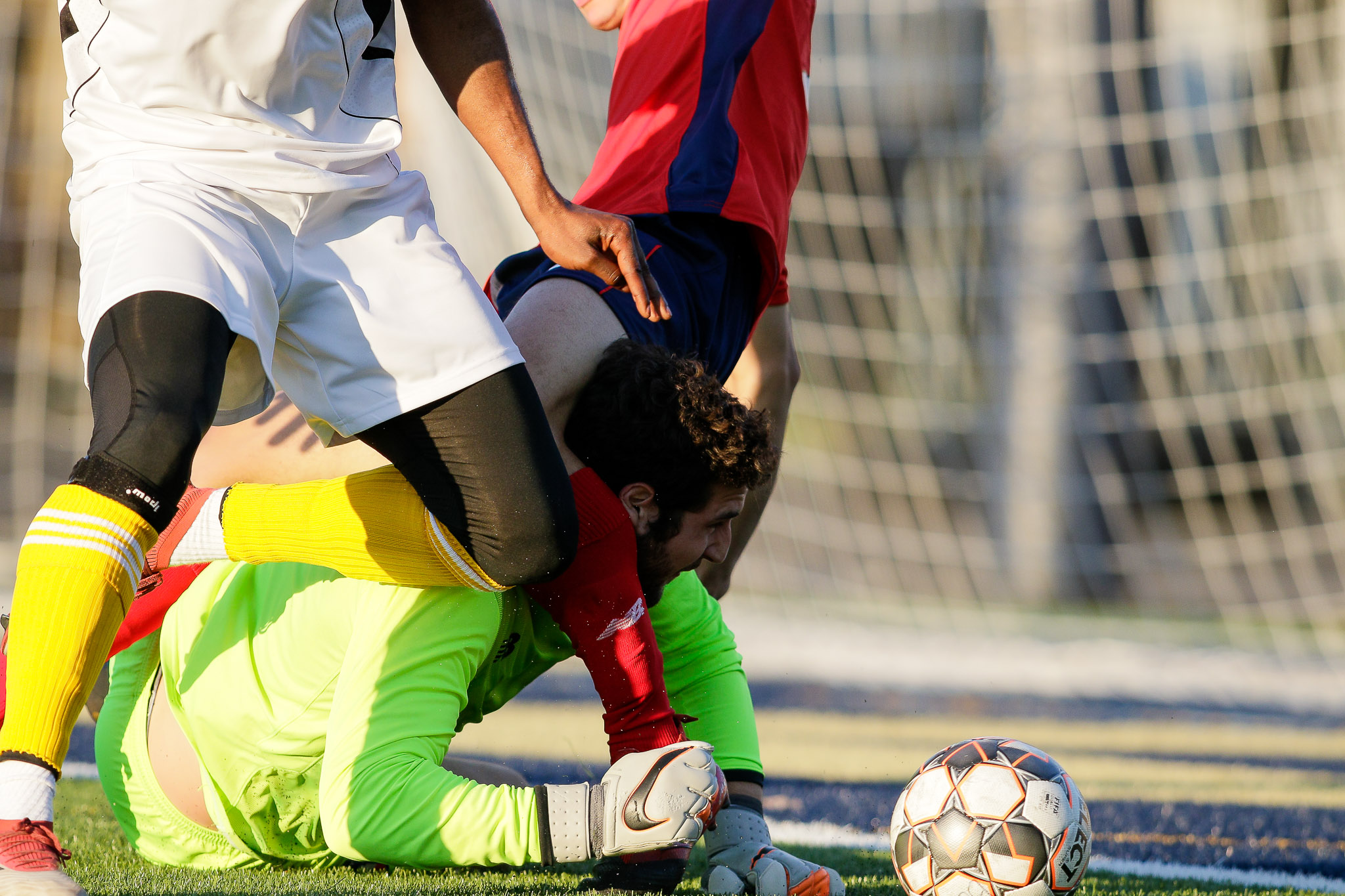  Boston City FC goalkeeper Jacob Wagmeister finds himself tangled up as he tries to retrieve the ball. (c) Burt Granofsky 