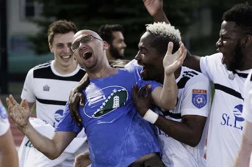 Father Tim Sas celebrates with his Duluth players. Image courtesy of USSF.