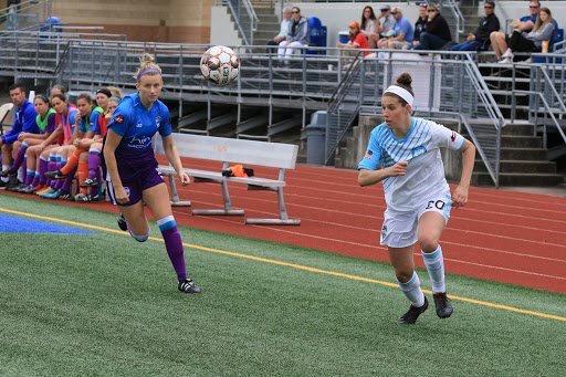 Cascadian rivalries transcend leagues, as Vancouver Island FC’s Rachel Baird (left) tries to a beat Seattle Sounders Women player to the ball. (Photo: League Website)