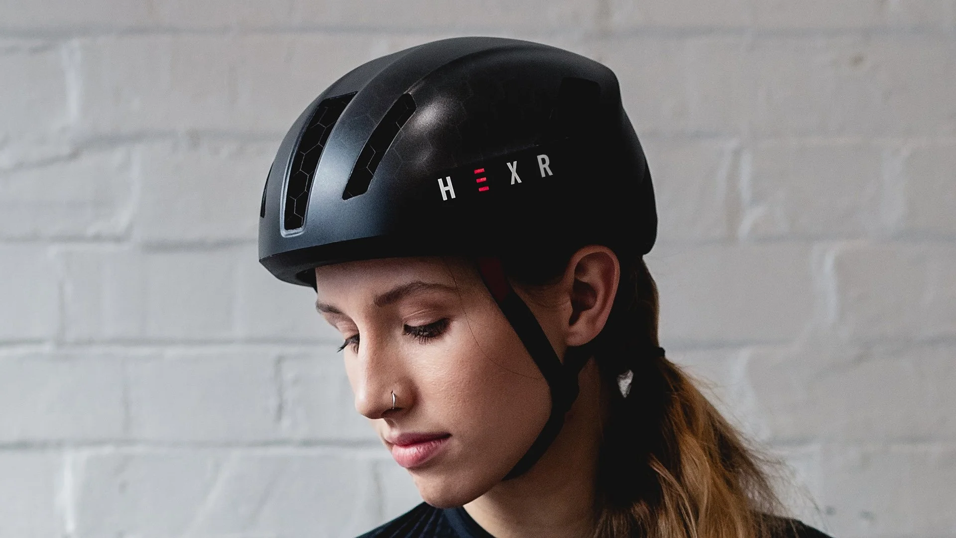 Hexr - helmet - photography - black - curventa - design - model - cycling - performance - transparent - hex - 3D print - aero - custom - headscan - orange - person - female cyclist - strap - goggles - hex - aerodynamic