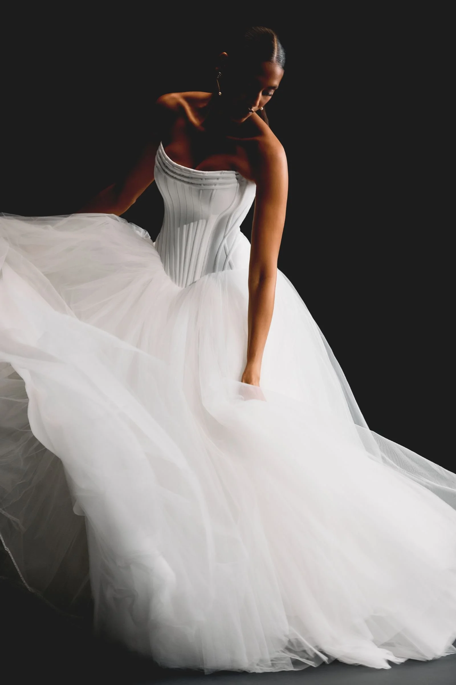Justin Alexander Signature Rhiannon satin and tulle ballgown with cat-eye neckline, exposed boning, corset bodice, dropped Basque waist and chapel-length train at & Wolf Bridal