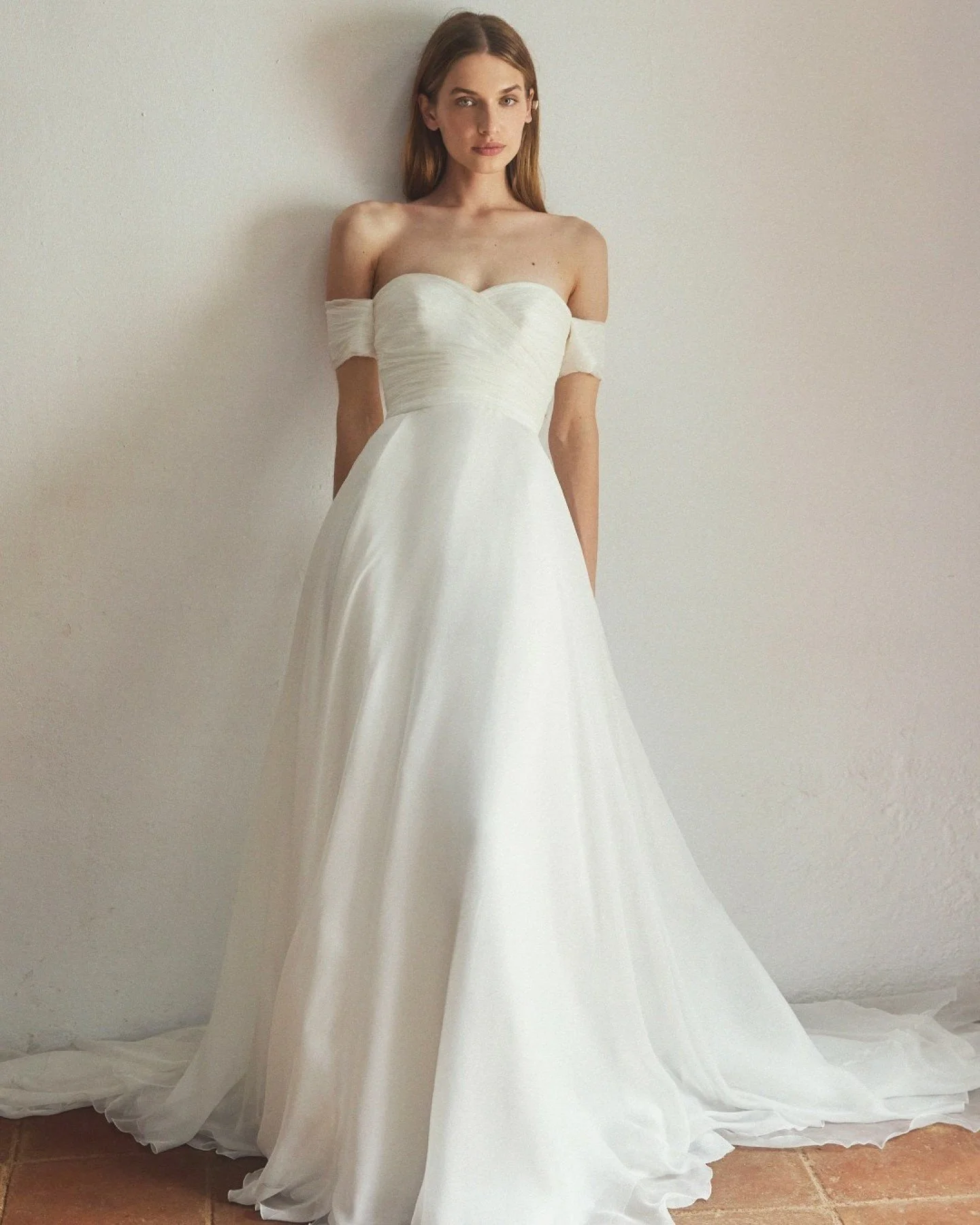 Introducing the 2550 gown by Jes&uacute;s Peir&oacute;: 

A seamless mix of classic tradition and contemporary romance in a wedding dress. With a softly draped sweetheart neckline and off‑the‑shoulder sleeves pay homage to timeless bridal silhouettes