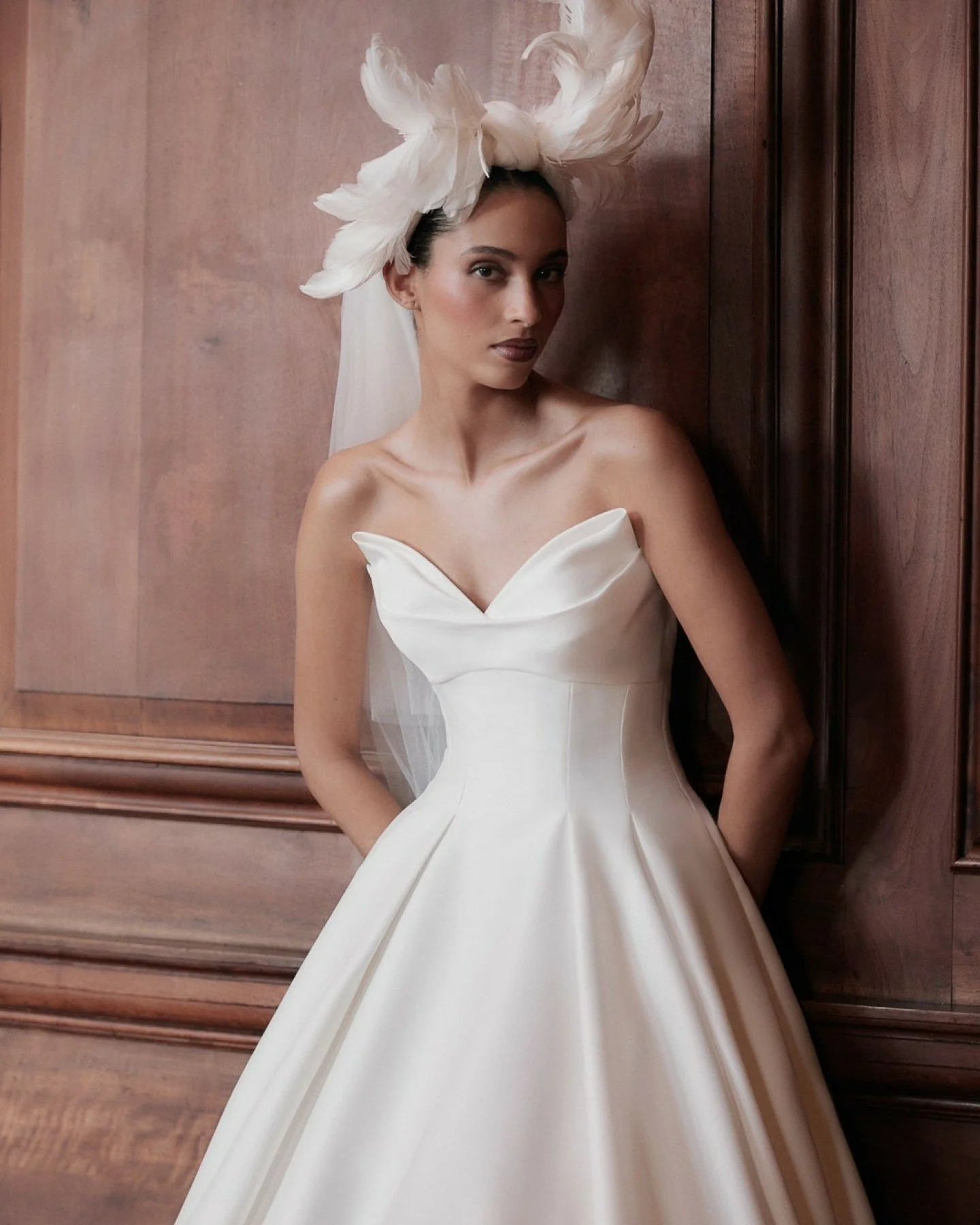 Meet Etta by Ellis Bridals, a Mikado Taffeta gown with a dramatic pointed neckline and a full, flowing skirt. With no waist seam, this dress gently elongates your silhouette and flatters natural curves. A timeless choice for brides who love structure