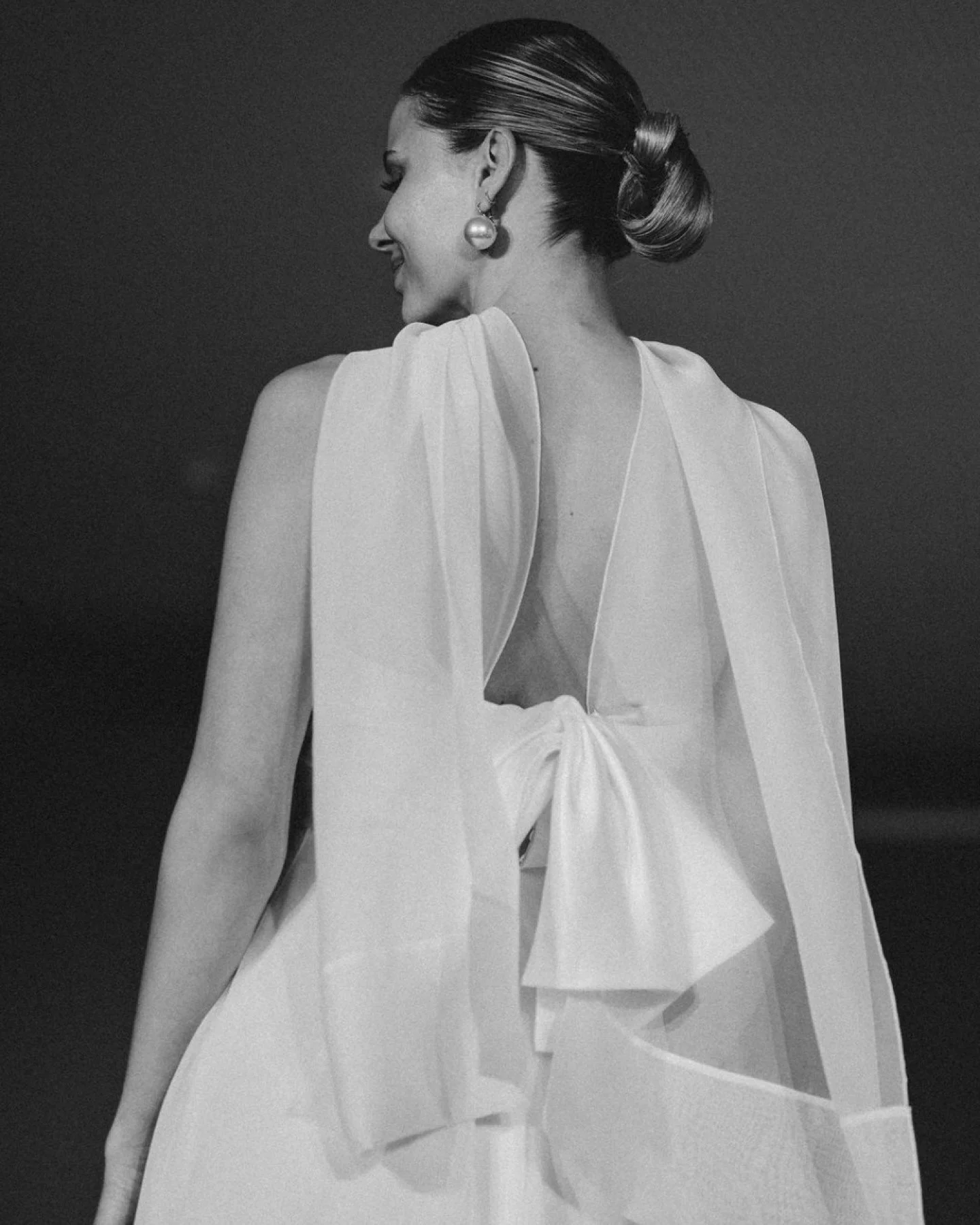 Introducing 2619 by Jesús Peiró is a strapless empire-waist gown in silk shantung with elegant draping and an hourglass-shaped chiffon skirt. The look is completed with a delicate mini shrug in bambula voile, creating a soft and romanti