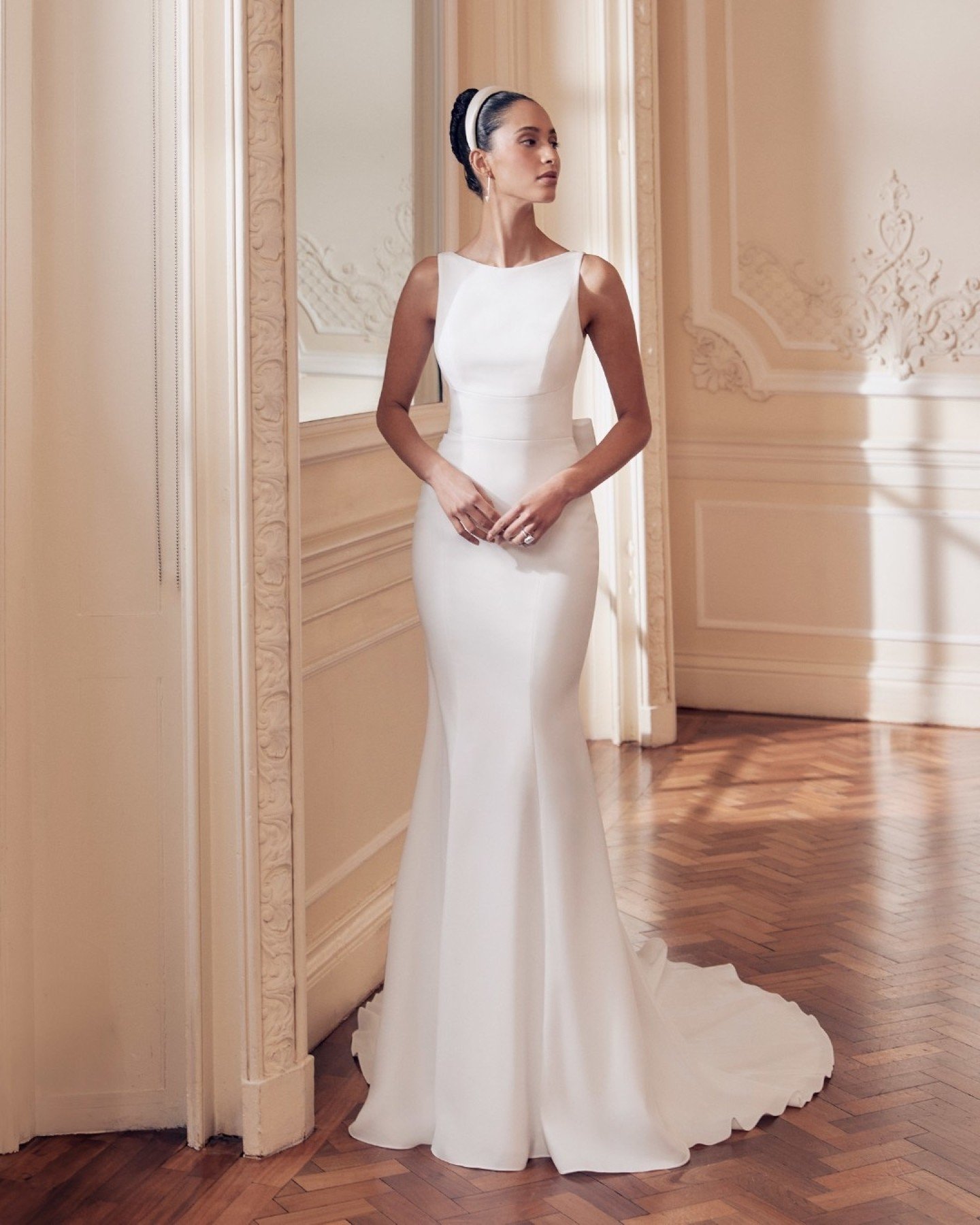 Quietly confident. Clean. Effortlessly modern.

Gwen by Ellis Bridals is a sleek crepe sheath gown designed for brides who love simplicity with intention. The refined boat neckline and wide waistband subtly define the waist, creating a silhouette tha
