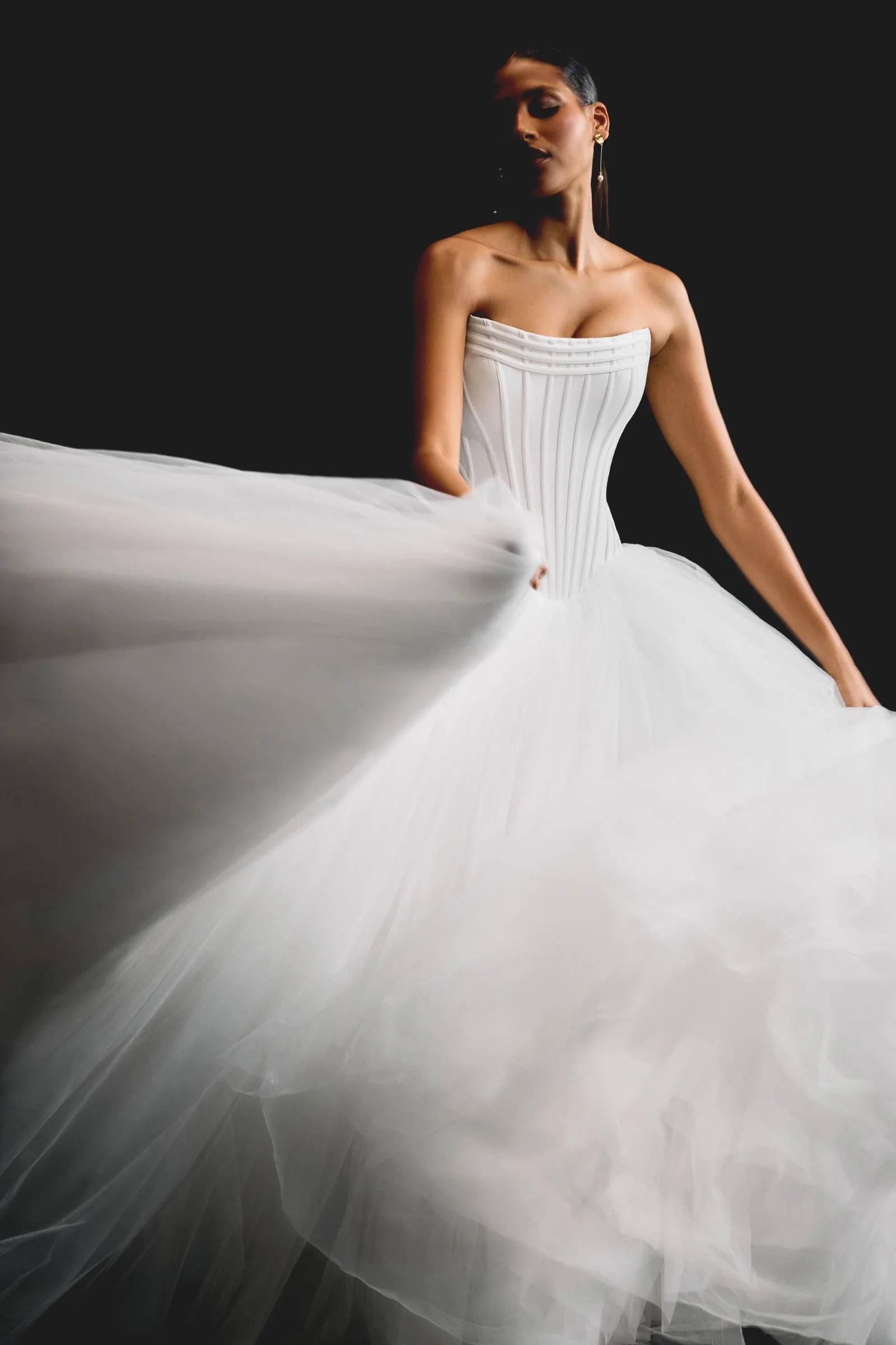 Justin Alexander Signature Rhiannon satin and tulle ballgown with cat-eye neckline, exposed boning, corset bodice, dropped Basque waist and chapel-length train at & Wolf Bridal