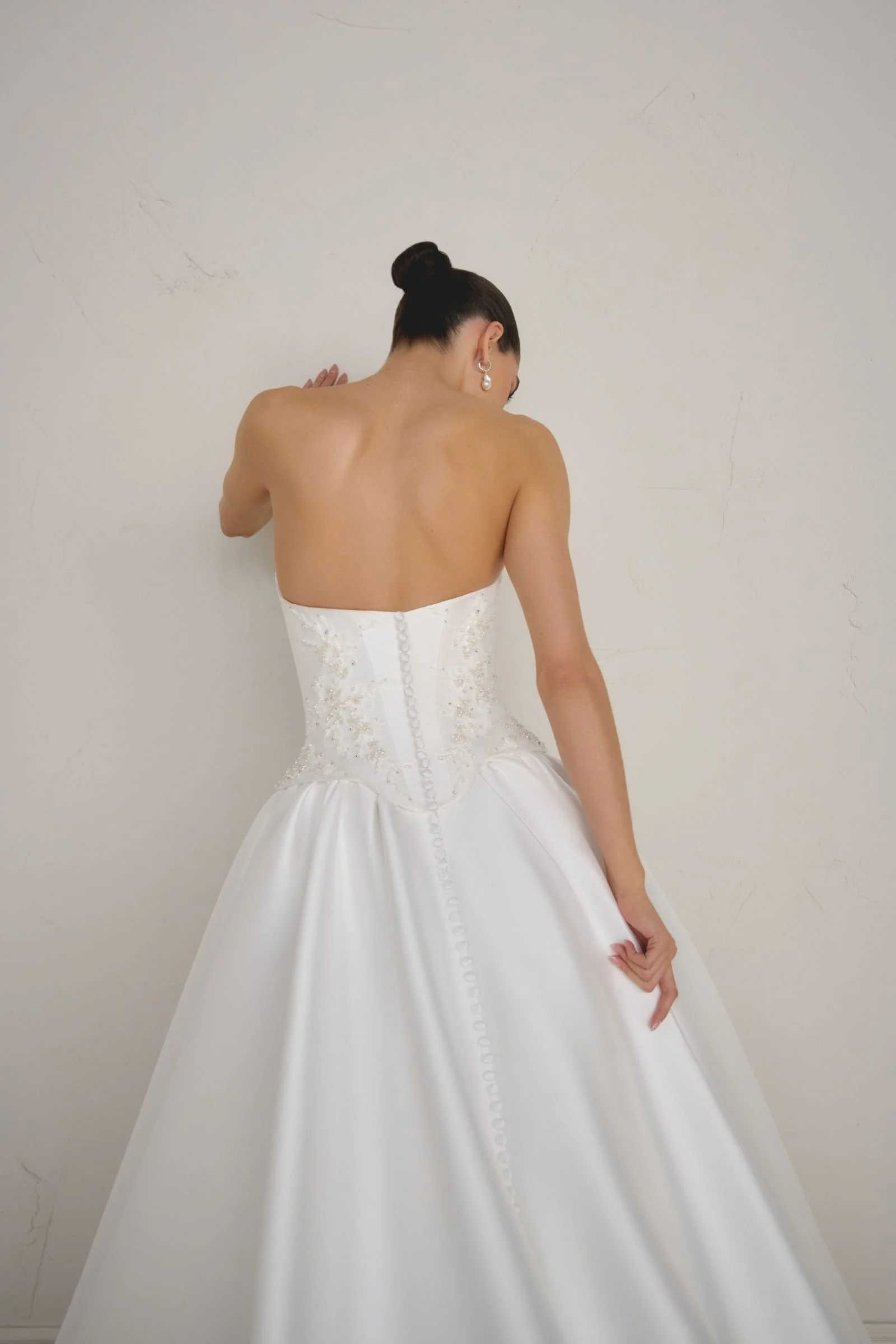 Justin Alexander Signature Solara Mikado ballgown with strapless cat-eye neckline, beaded corset bodice, Basque waist and cathedral-length train. available to try on at & Wolf Bridal, Marlborough