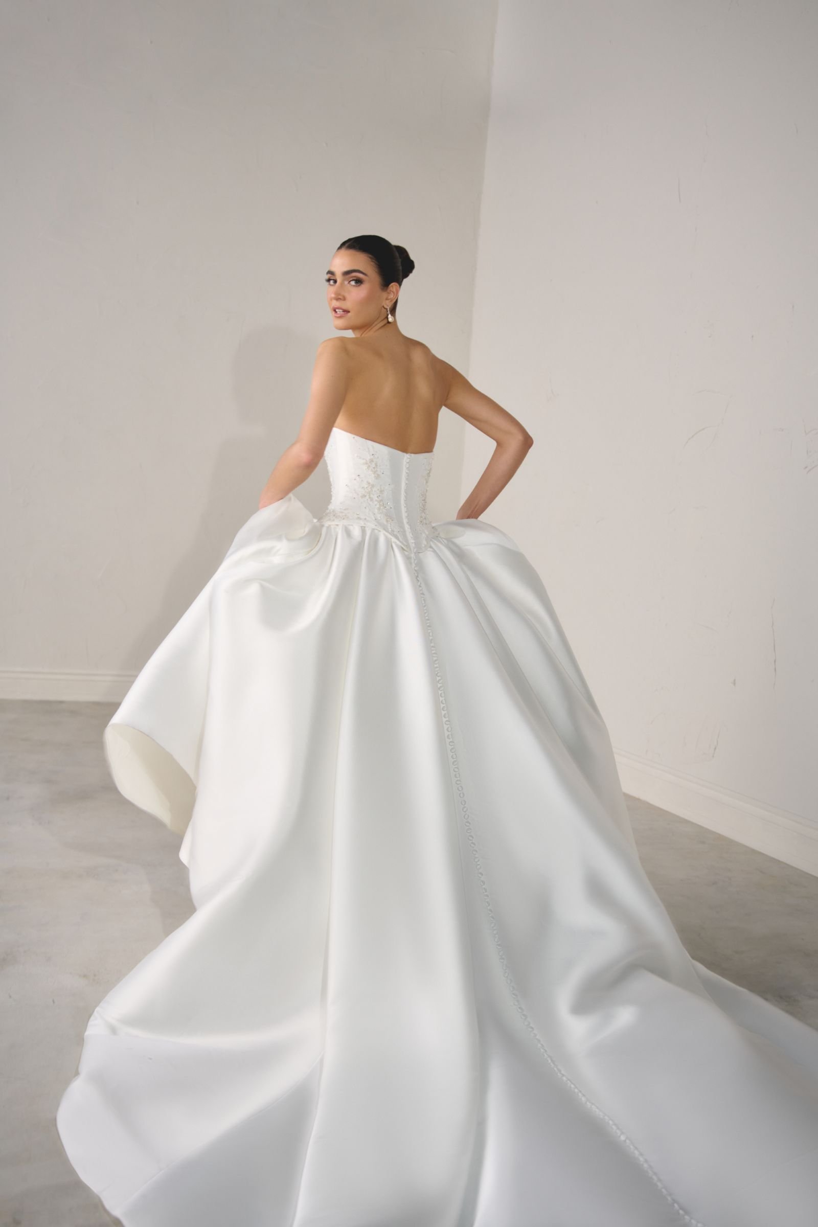 Justin Alexander Signature Solara Mikado ballgown with strapless cat-eye neckline, beaded corset bodice, Basque waist and cathedral-length train. available to try on at & Wolf Bridal, Marlborough