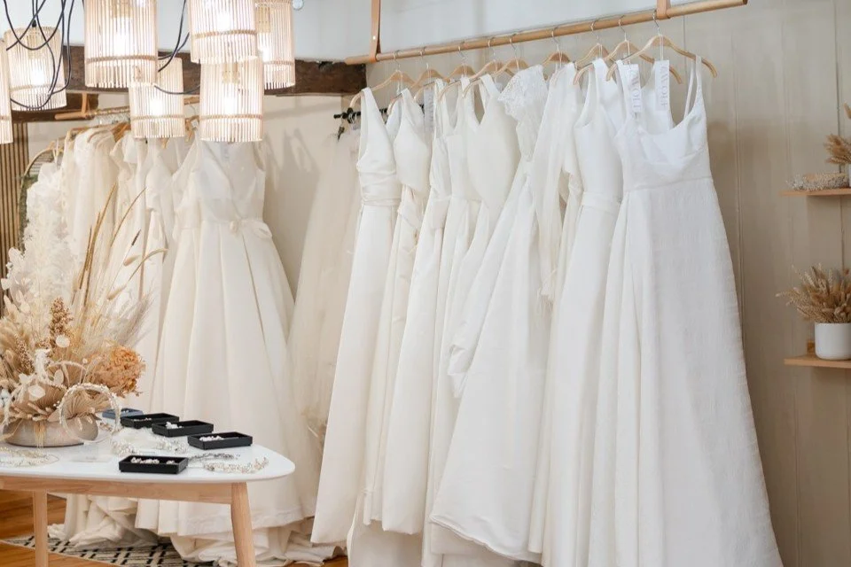 Rail of modern designer wedding dresses at & Wolf Bridal in Marlborough, Wiltshire, available Off-the-Peg.