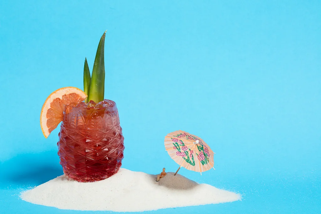 Amity Island cocktail in pineapple glass with decorative umbrella