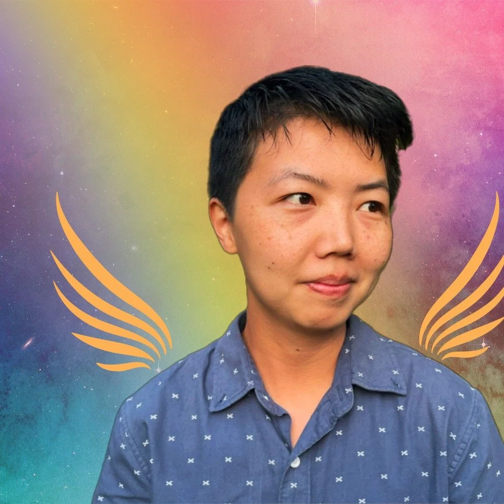 You Belong Here Web Developer Jin, a light-skinned Asian person with short dark hair, in front of a rainbow gradient with stylized wings.