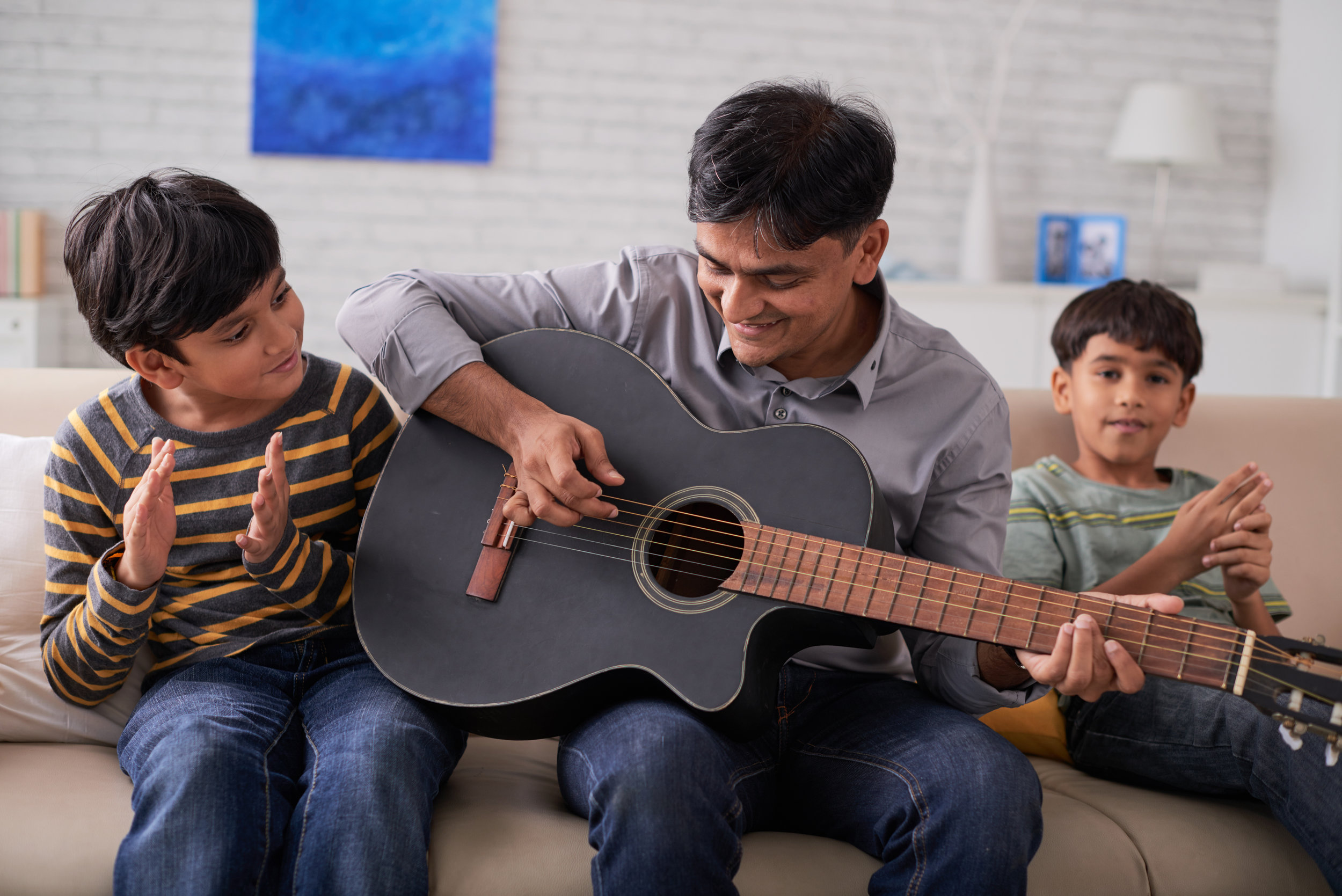 father_two_sons_guitar.jpeg