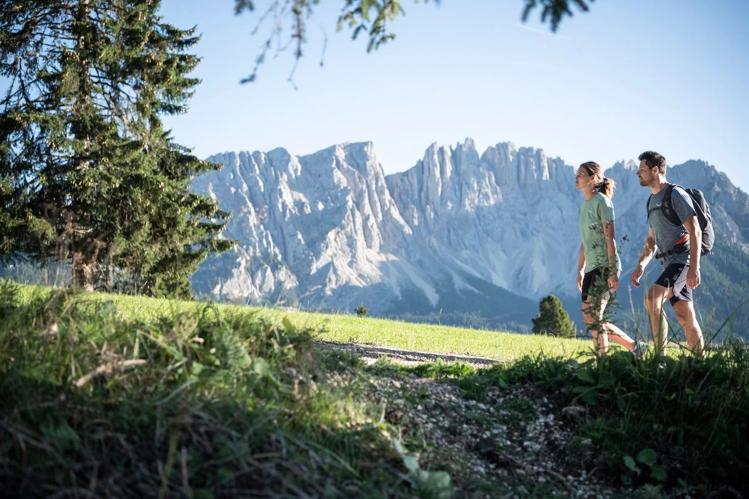 A guided group hiking a mountain trail through the Dolomites