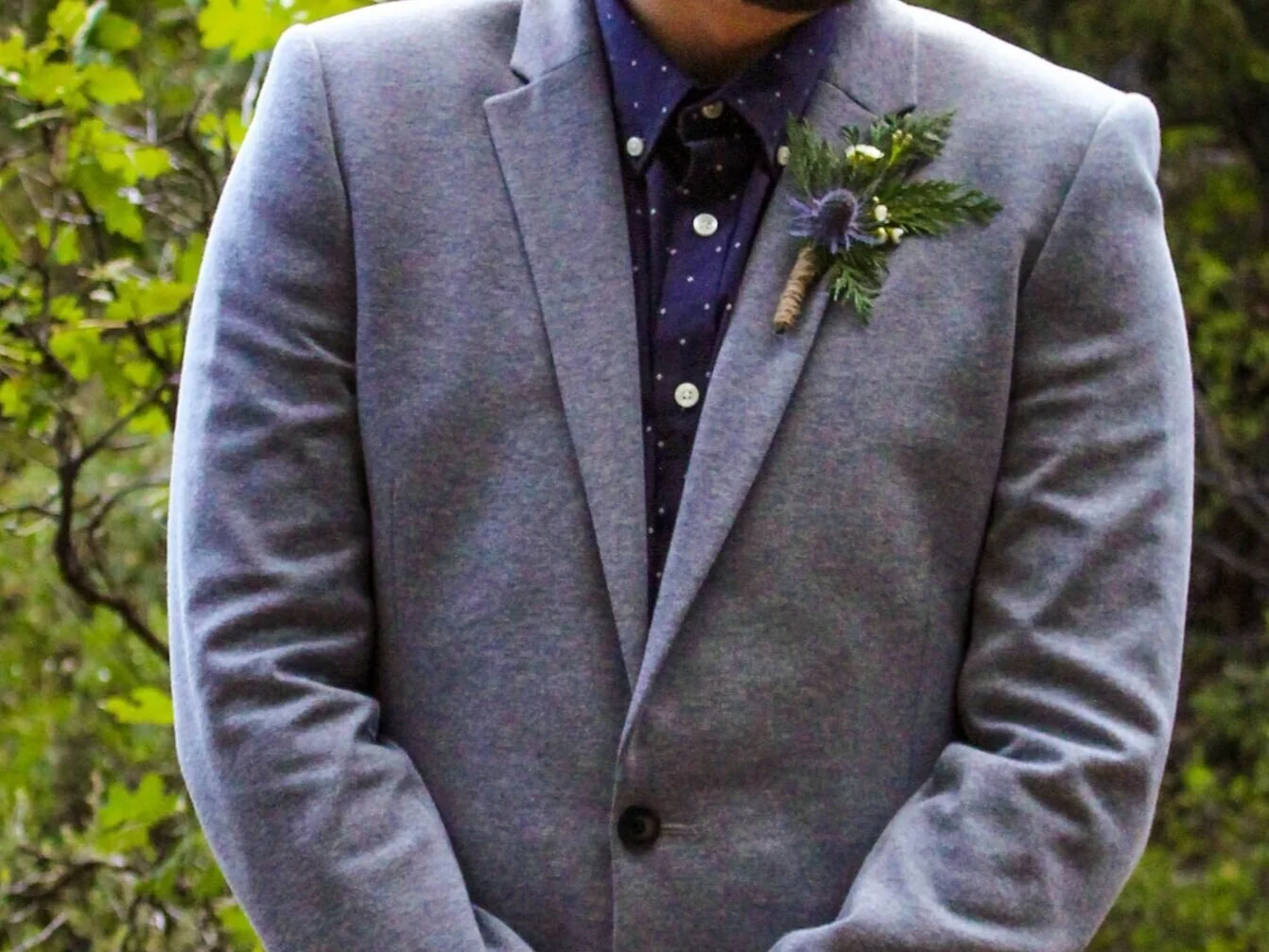 groom with cottagecore boutonniere