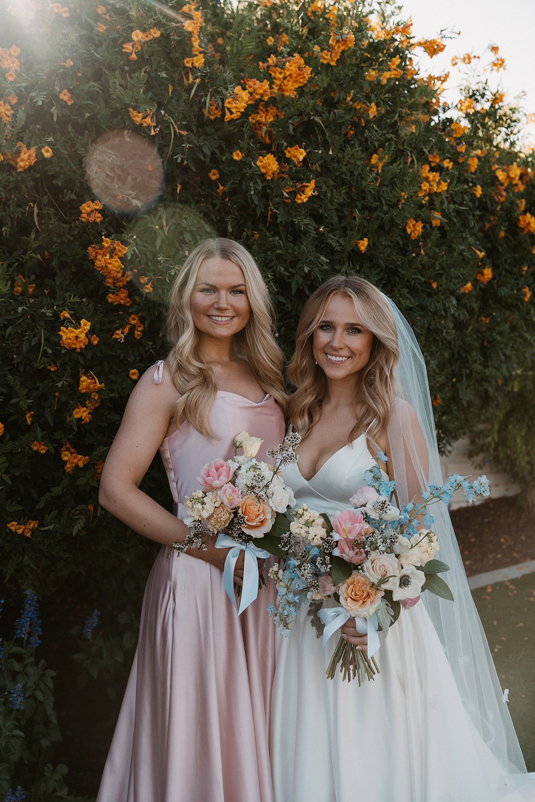 Pastel wedding bride with bridesmaid