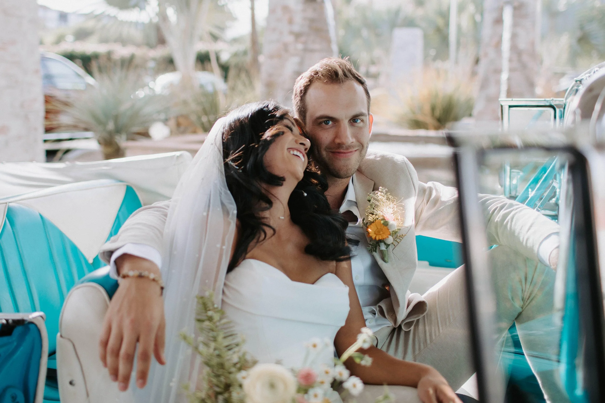 Smiling groom in classic car