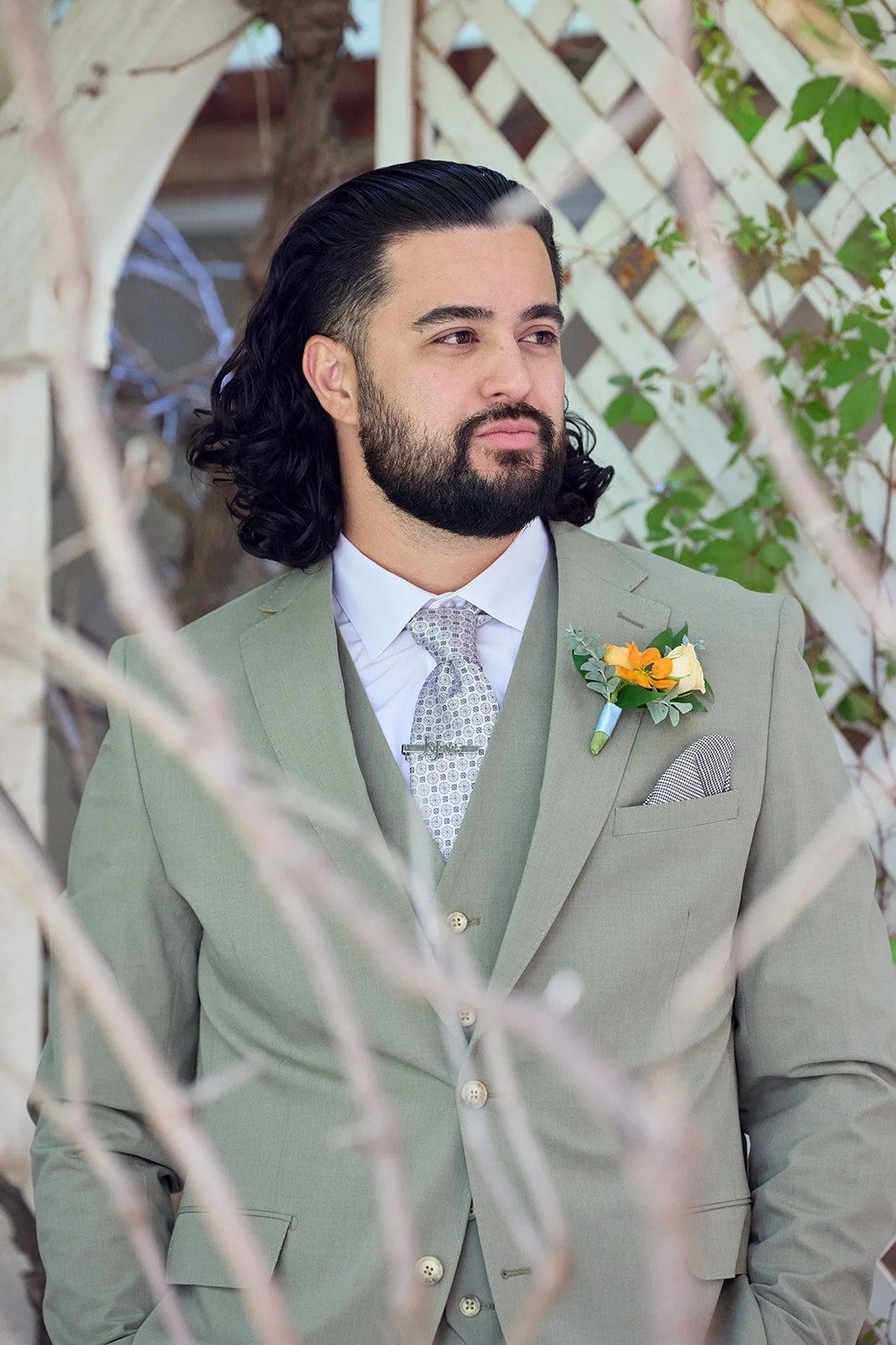 Groom with orange and peach boutonniere