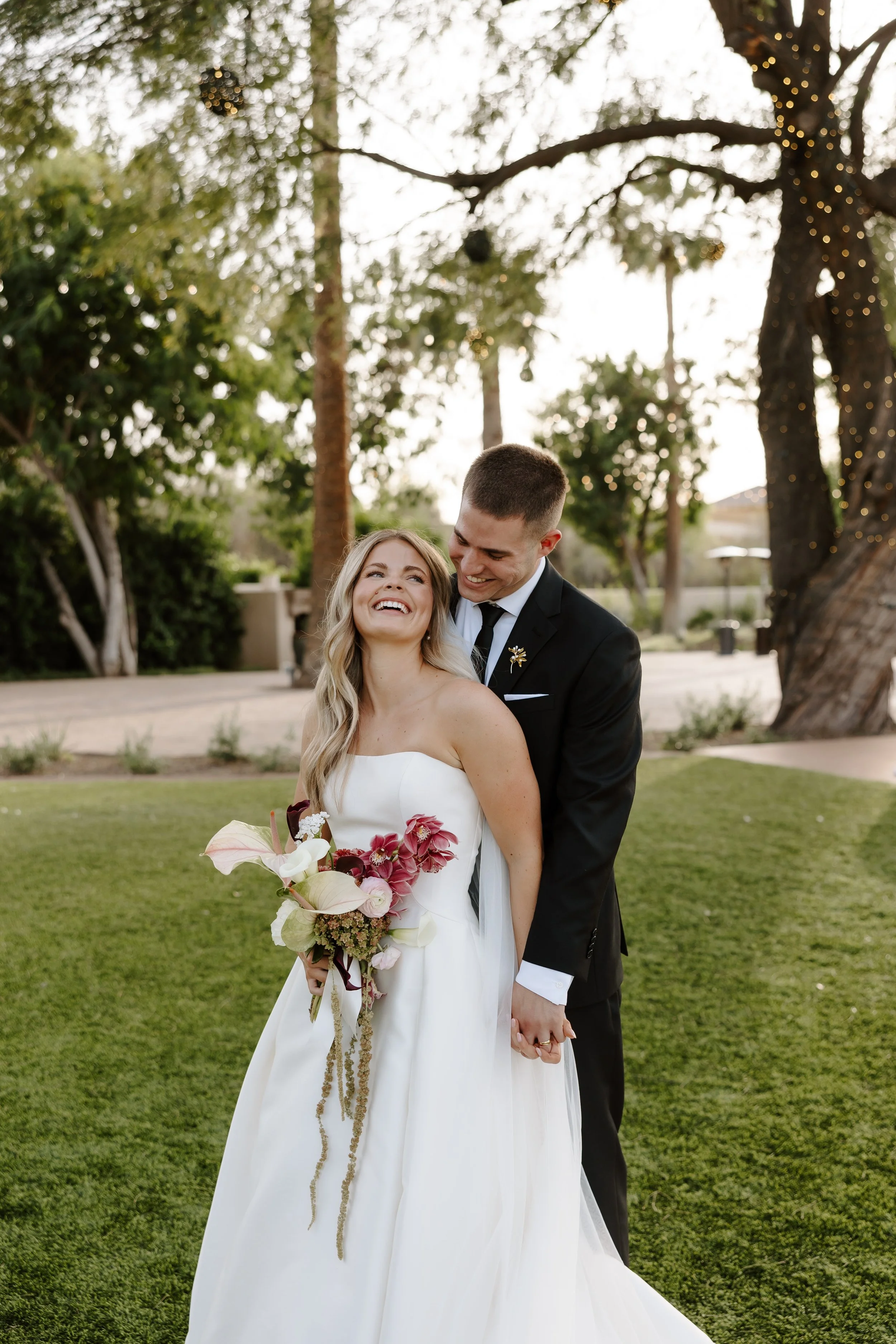 Happy bride and groom with wedding bouquet