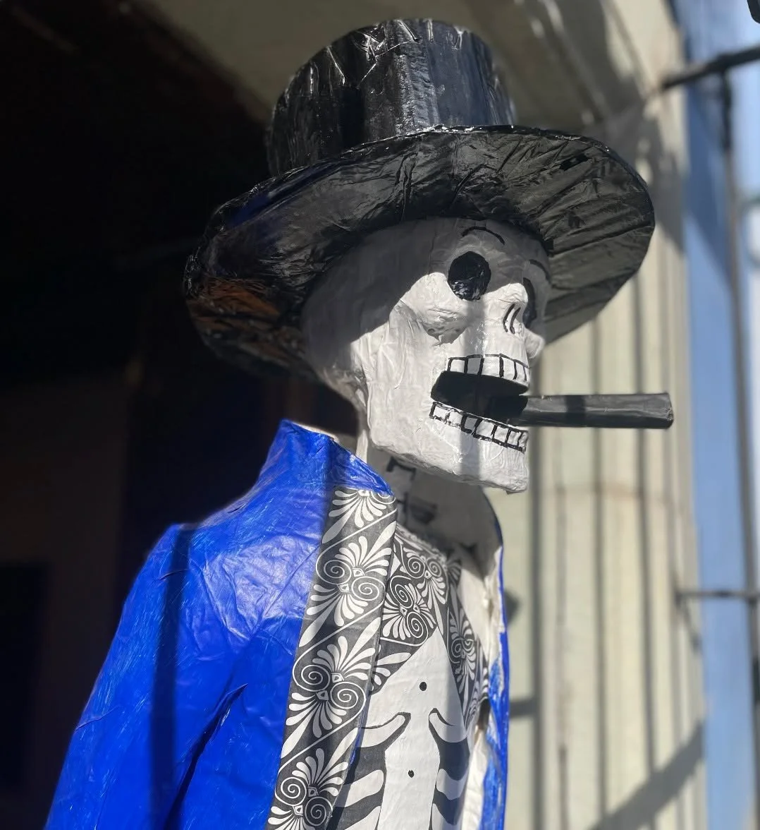 Everywhere I turn, skeletons are multiplying. They are dancing, swinging, bicycling, shopping, and enjoying coffee at the table across from me. Death in Oaxaca is not hidden away but instead, is alive in this city’s imagination and daily life.