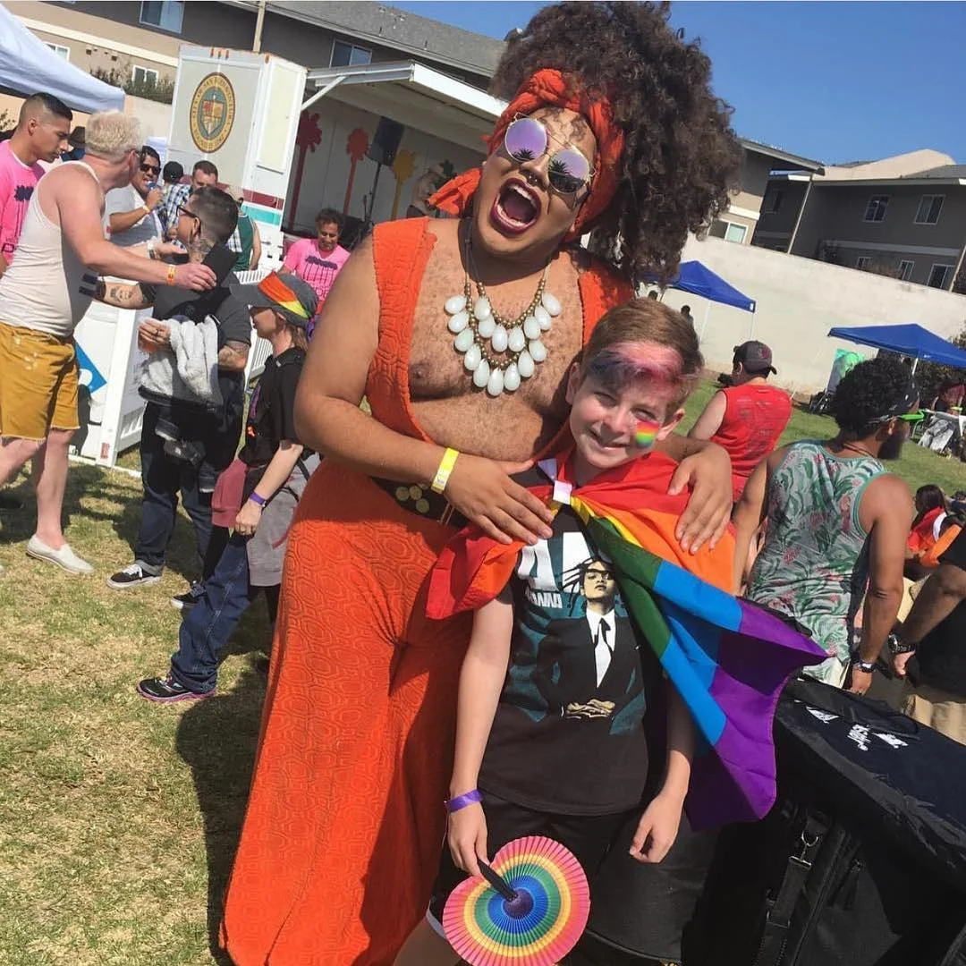 Dragula’s Meatball draggin’ it up at Ventura County Pride in our vintage orange jumpsuit and white costume necklace (via @spiciestmeatball via Instagram)