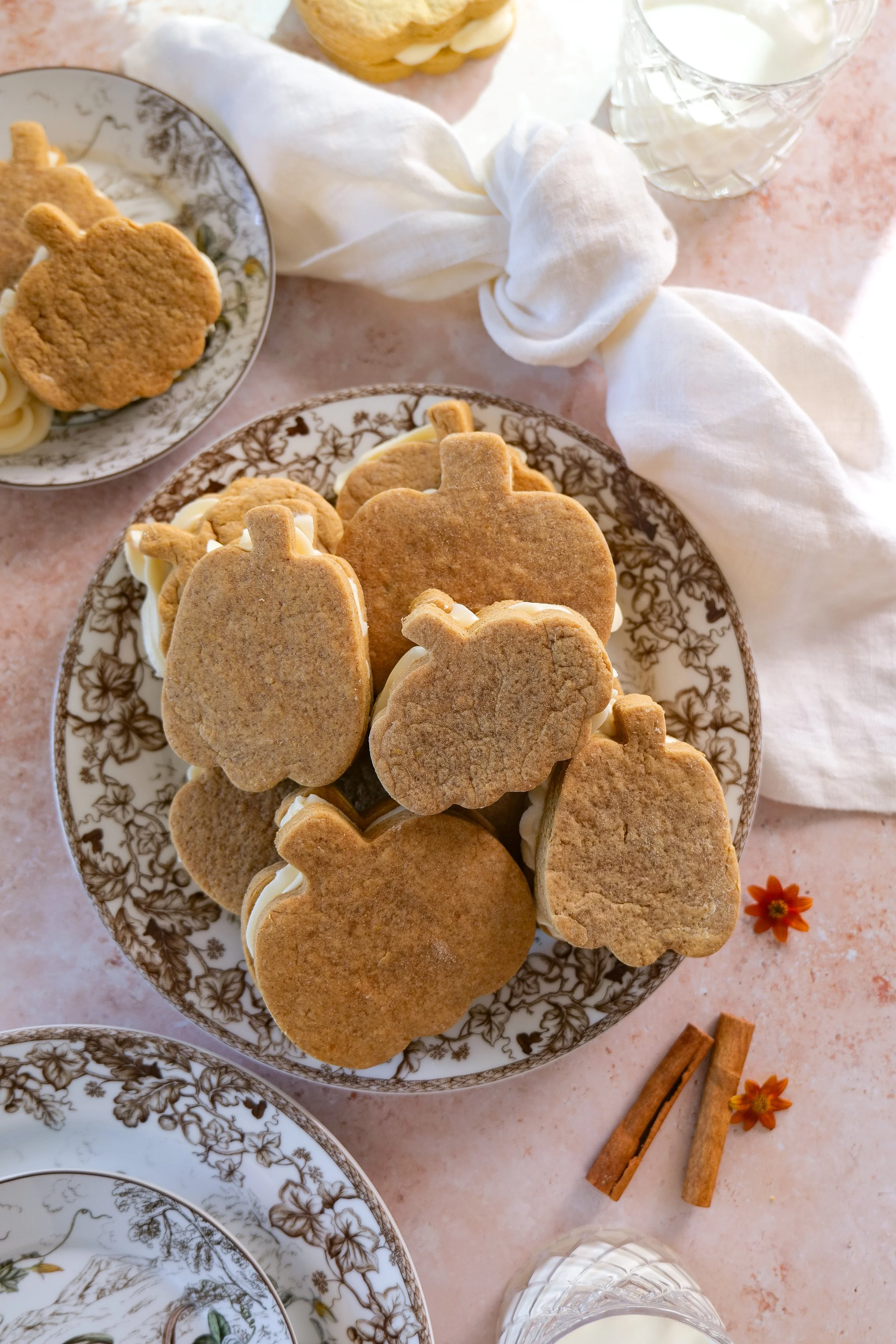 Close-up of a brown butter pumpkin sandwich cookie with cream cheese center
