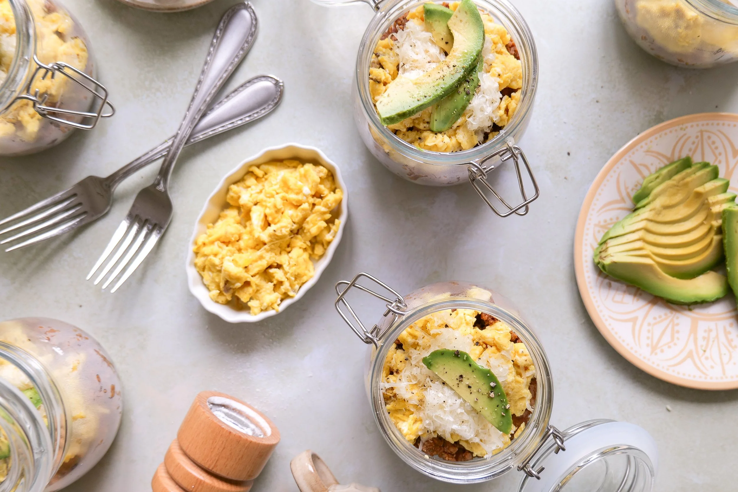 Homemade chorizo and crispy potato breakfast bowl with scrambled eggs, cheese and avocado.