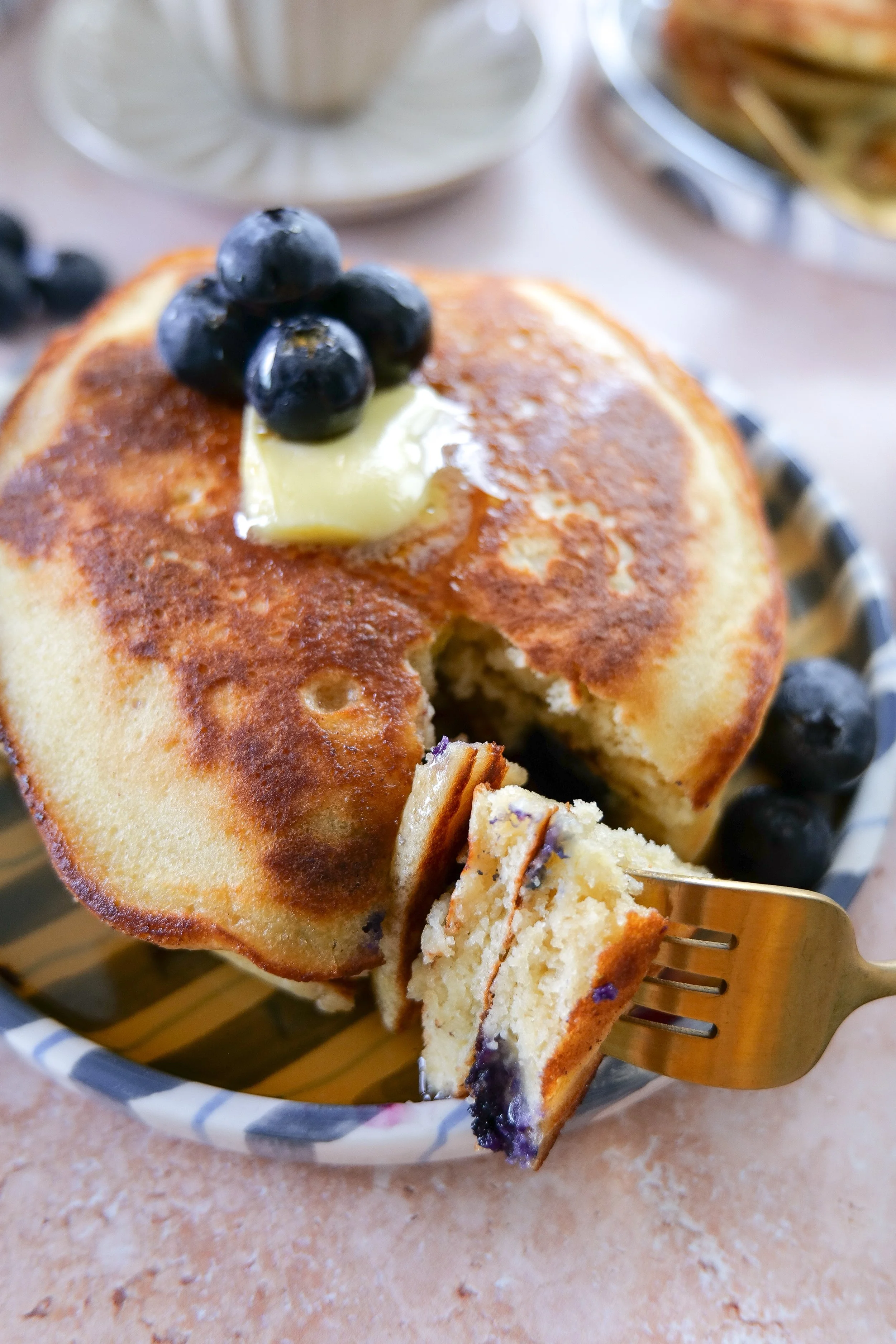 Sourdough discard breakfast pancakes topped with maple syrup and blueberries.