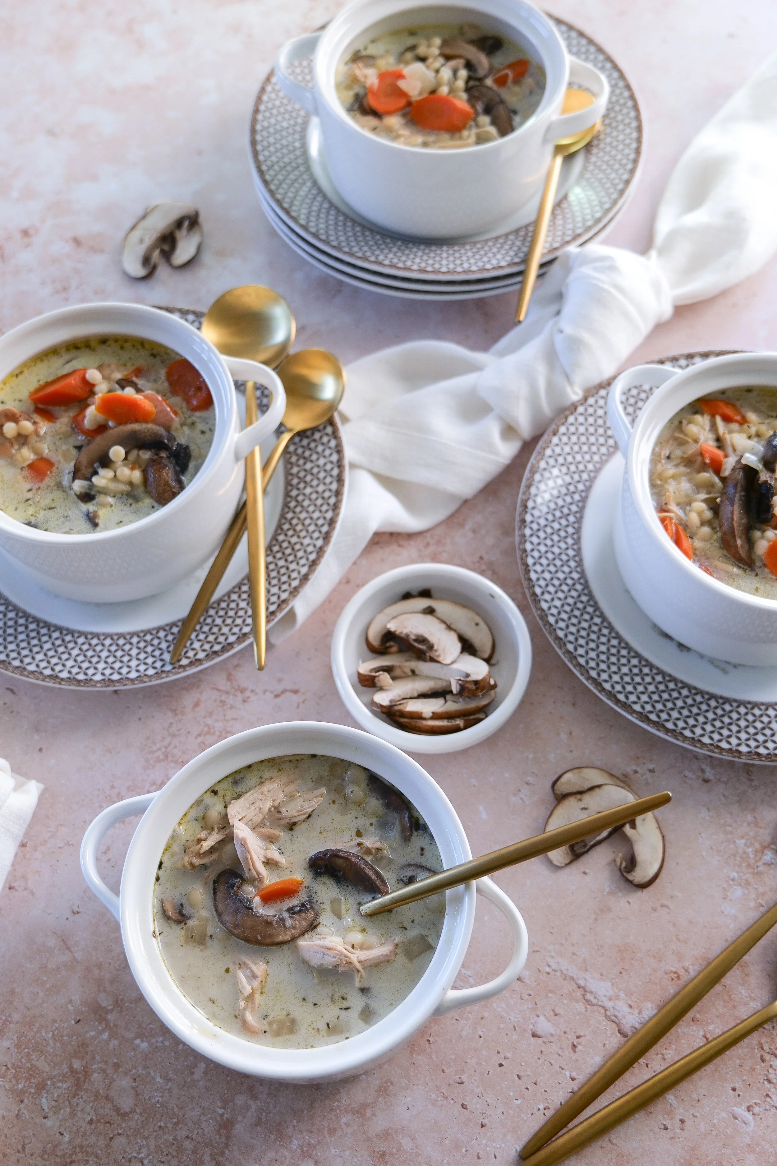 Homemade creamy chicken couscous soup with tender chicken, mushrooms and vegetables.