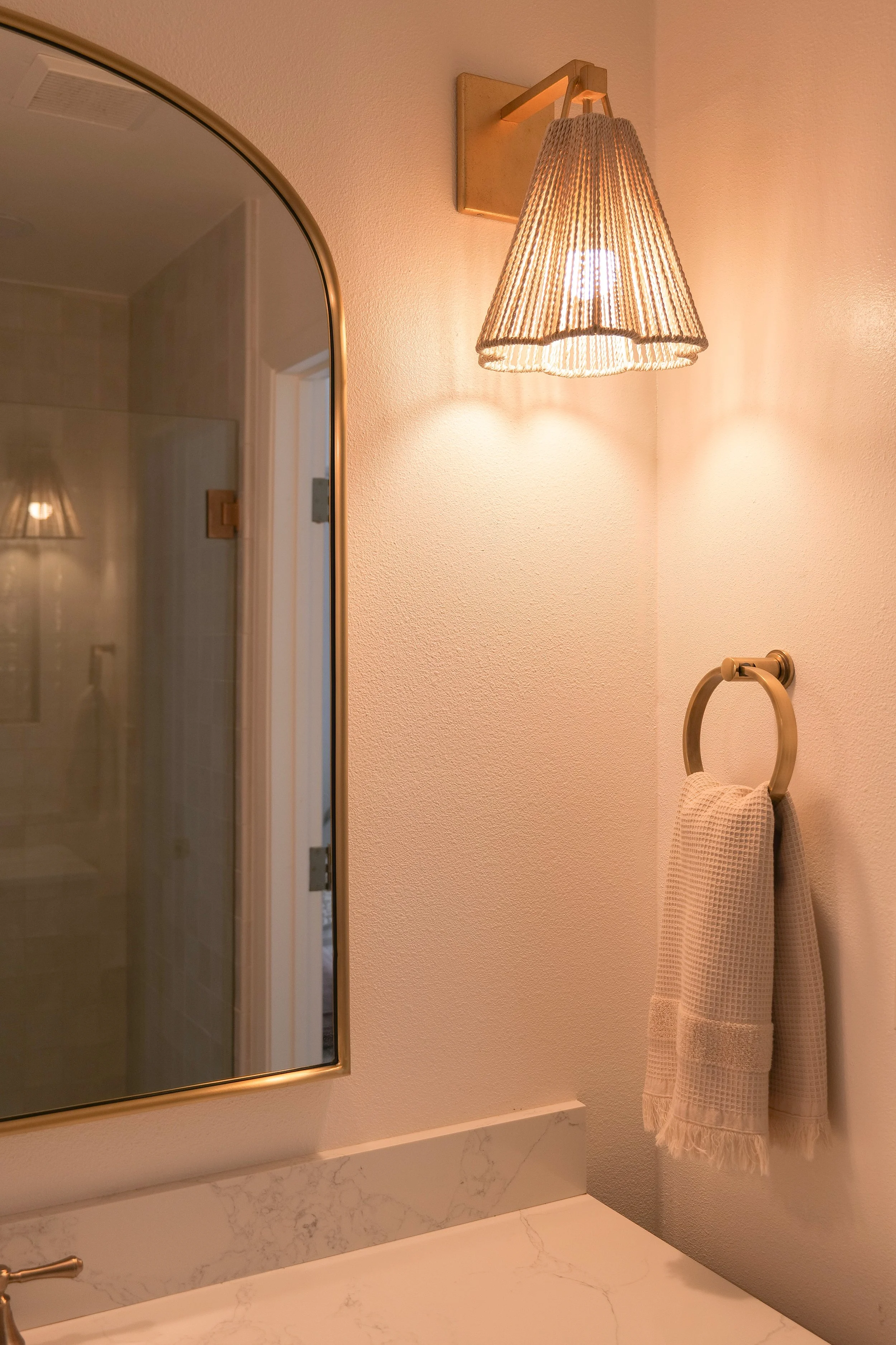 Warm tan towels coordinating with the bathroom vanity and floor tile.
