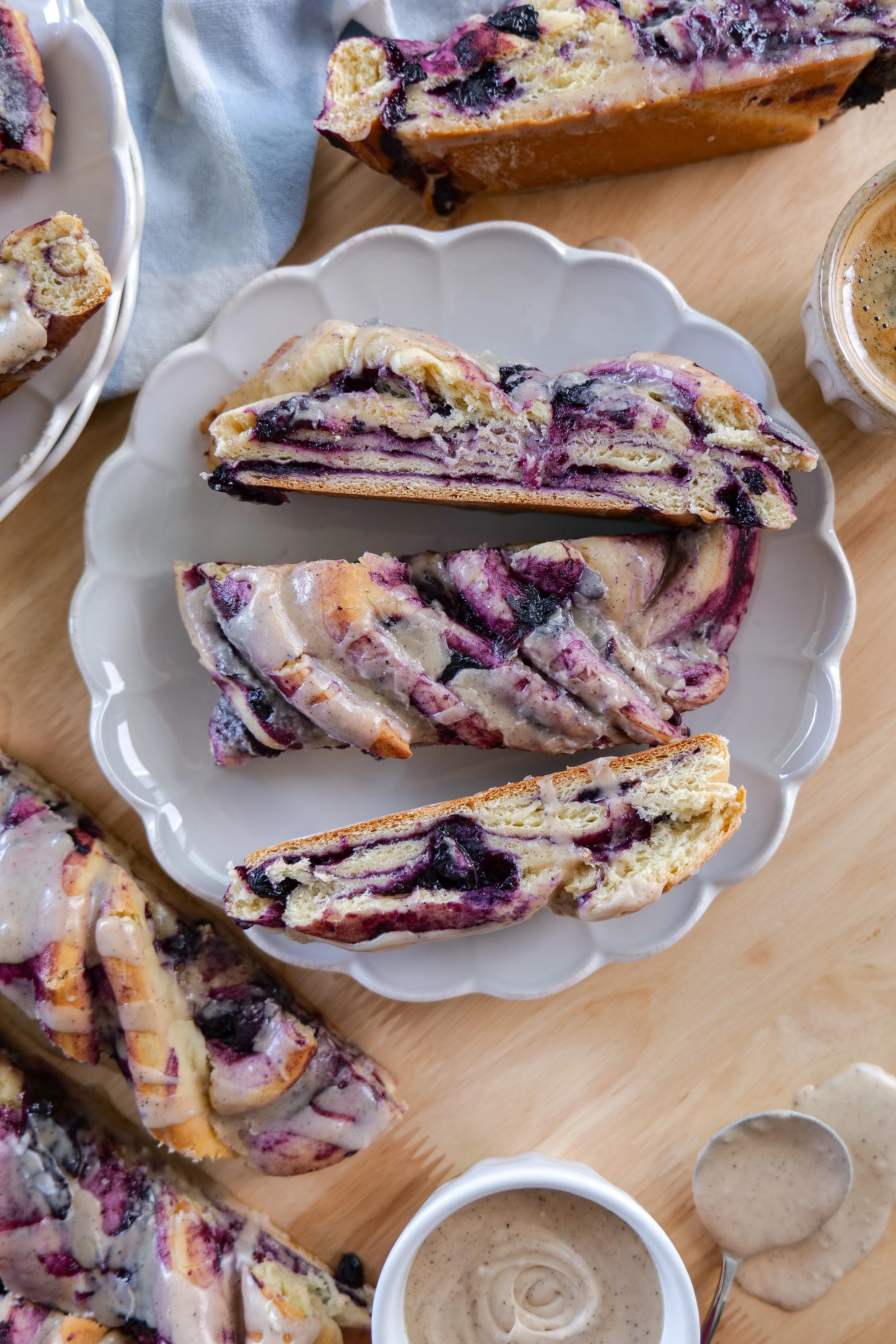 Sliced blueberry cinnamon roll loaf showing soft bread and layers of blueberry cinnamon filling.
