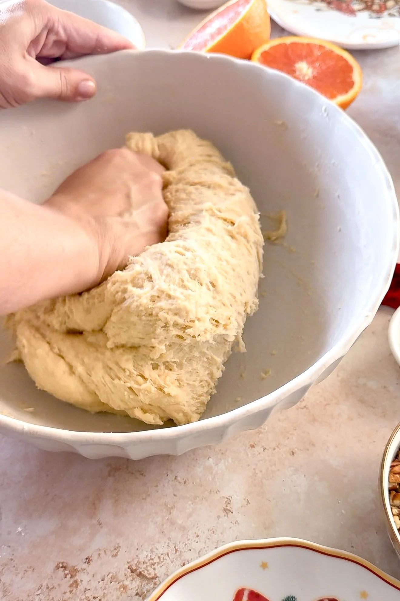 Soft homemade cinnamon roll dough being prepared for orange pecan cinnamon rolls.