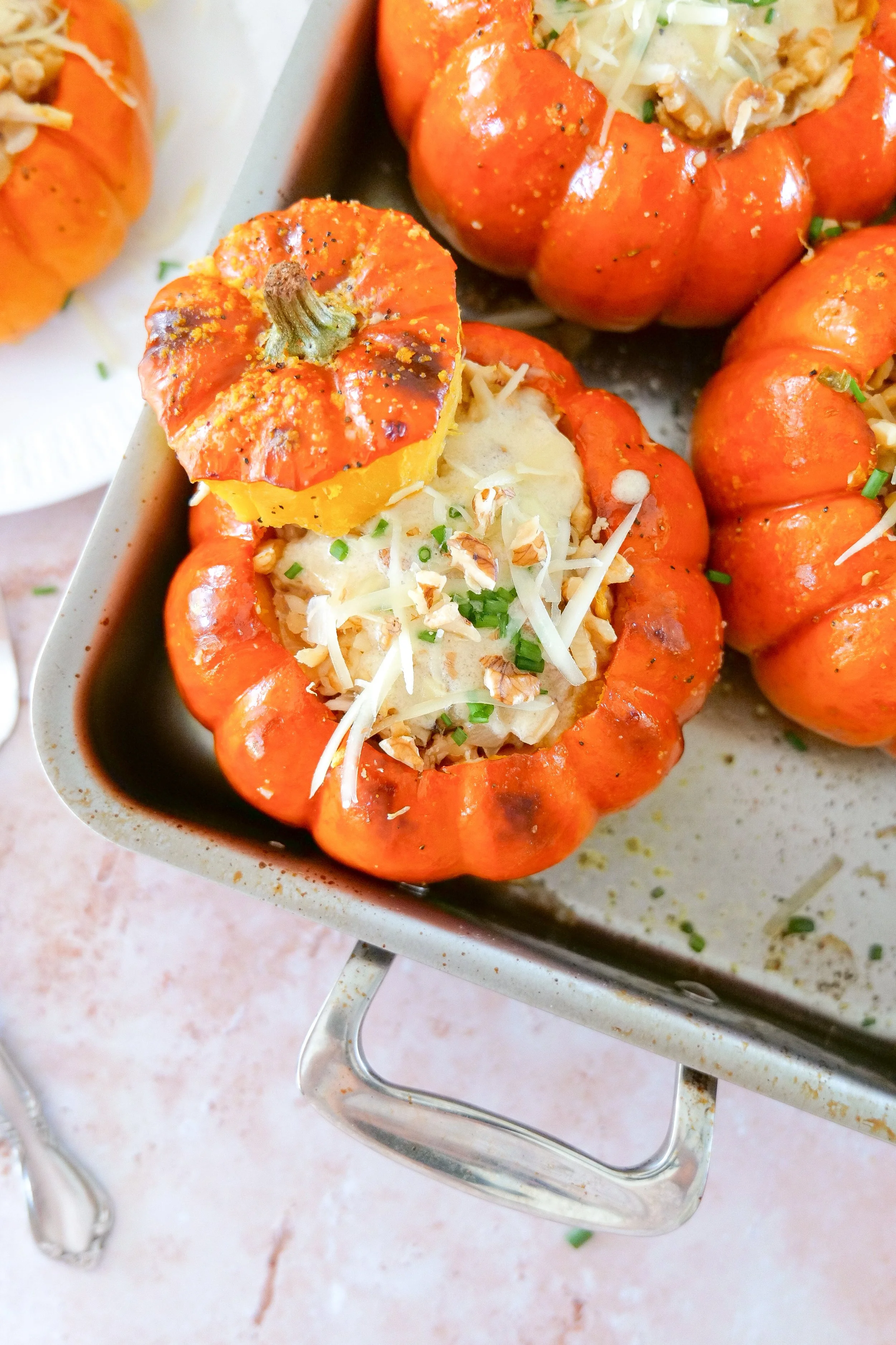 Individual stuffed pumpkin served as a festive autumn main dish.