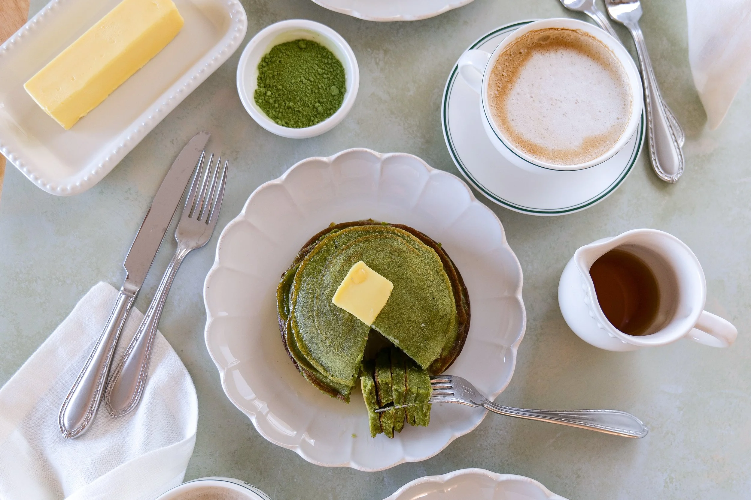 Matcha sourdough discard pancakes served with butter on top