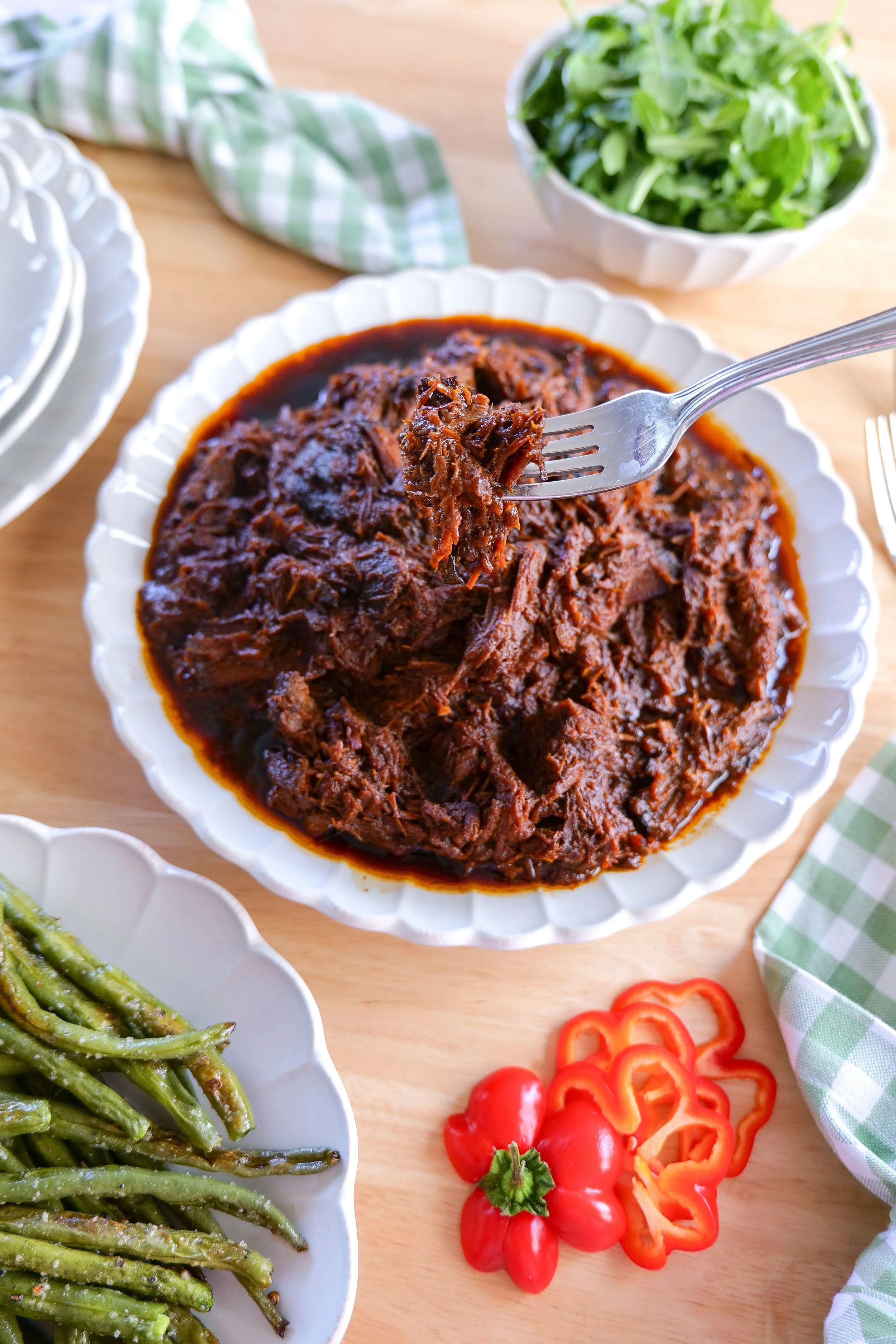 Tender shredded slow cooker BBQ brisket served with its savory BBQ cooking juices.